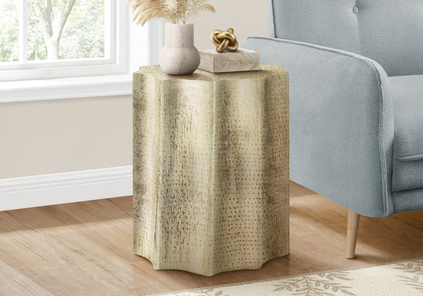 Textured gold starburst pedestal accent table with decorative accents