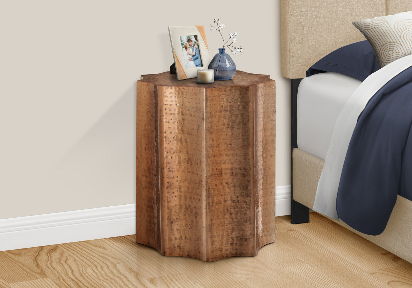 Hammered copper accent table with unique geometric design ideal for bedside storage