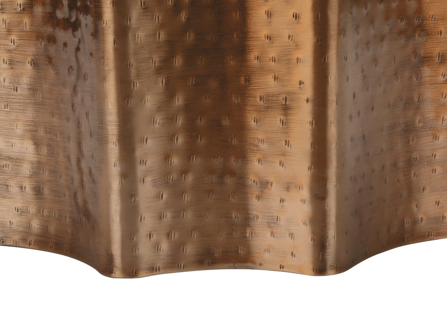 Closeup of hammered antique bronze metal finish with a textured pattern