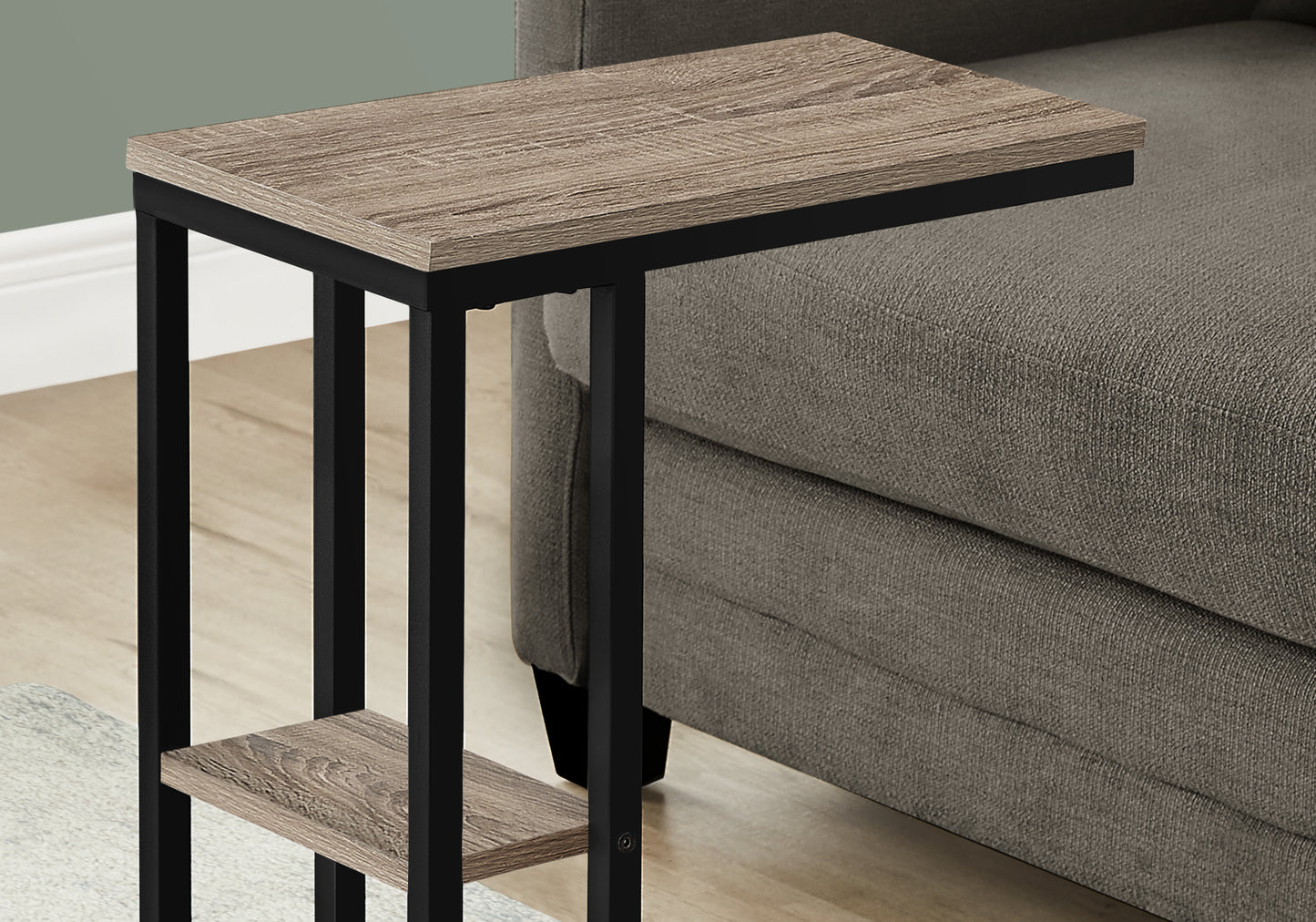 Modern ctable with rustic wood top and black metal frame next to sofa