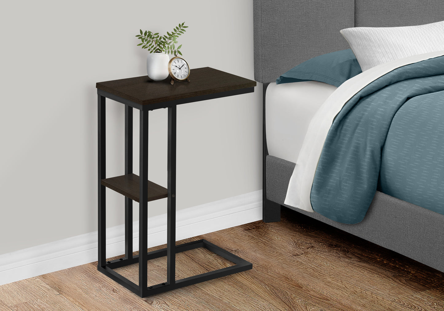 Dark wood and black metal Ctable with minimalist design and a decorative clock and vase