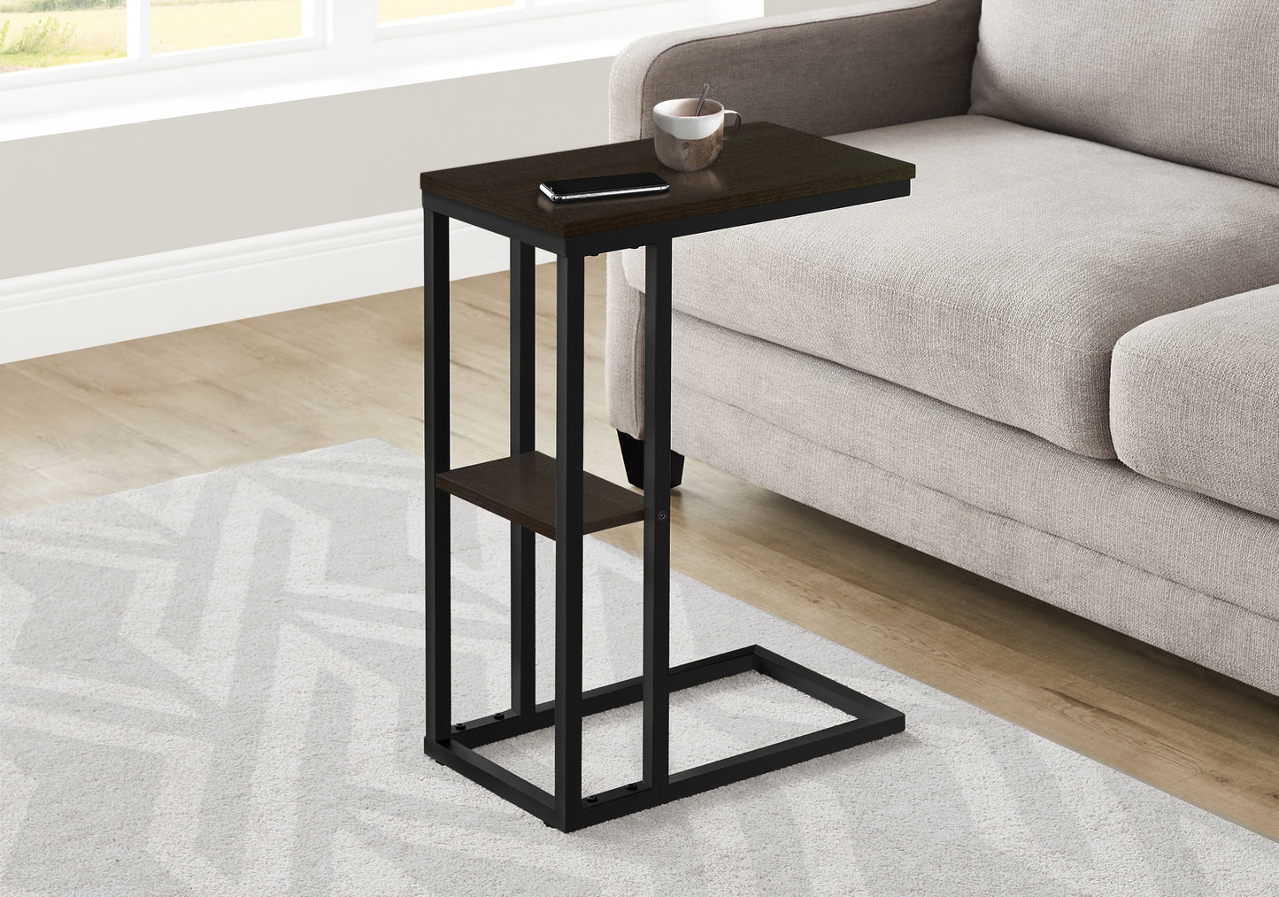Dark brown ctable with black metal frame beside a light gray sofa