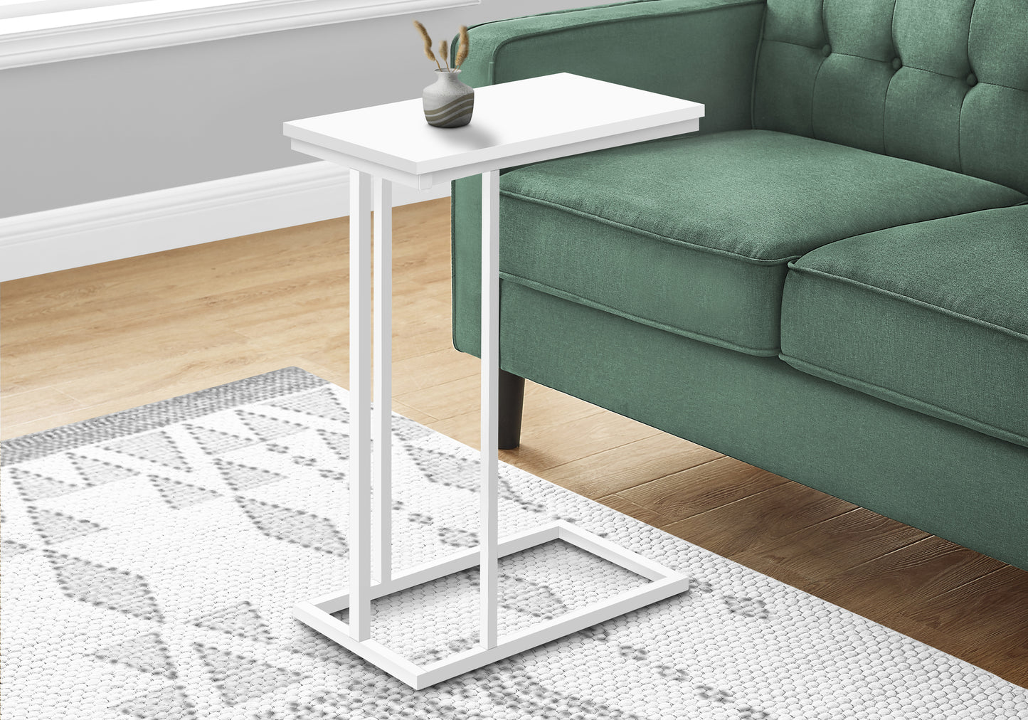 White modern ctable with narrow base for living room use beside a sofa