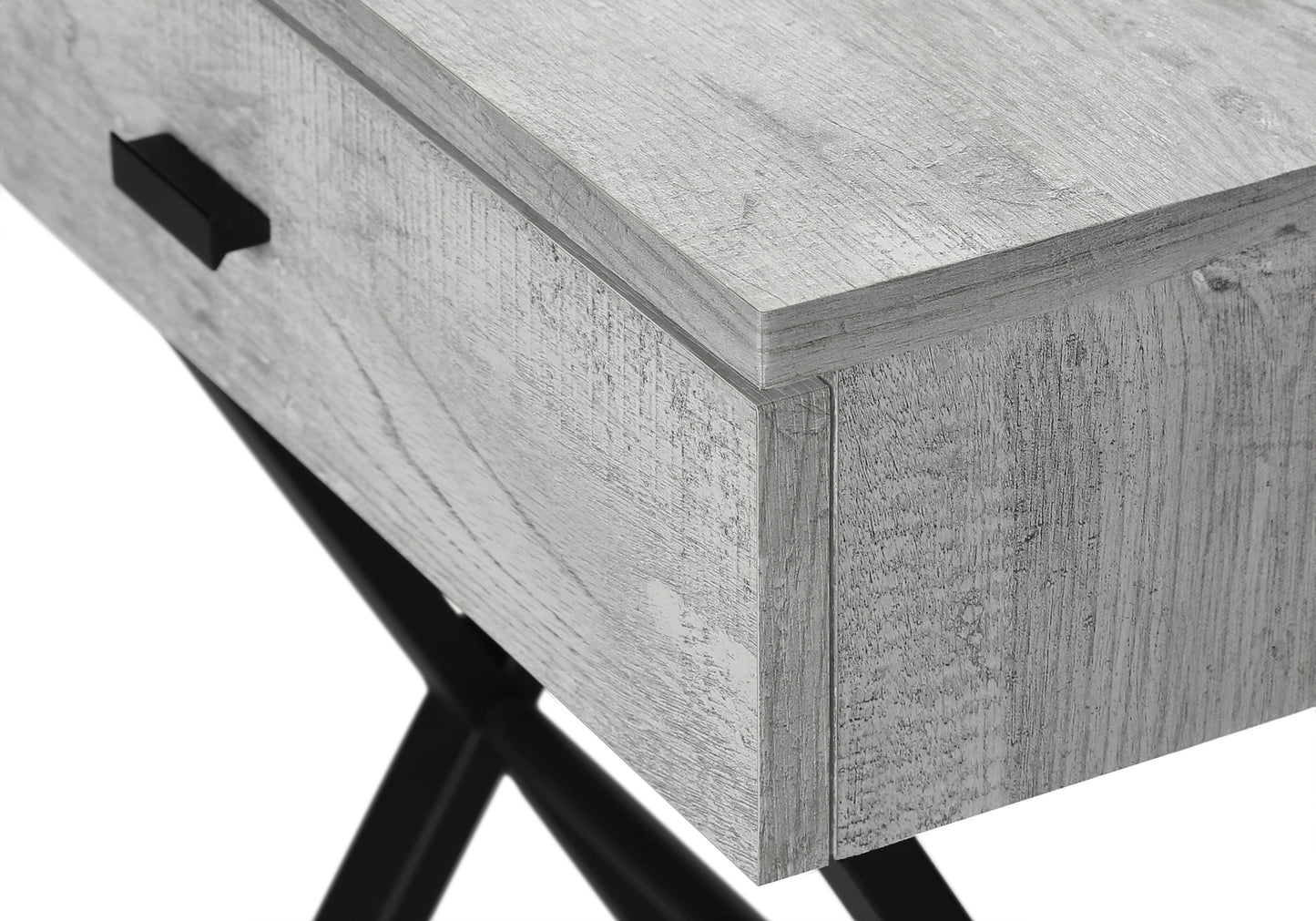 Closeup of gray wood grain side table with black drawer pull