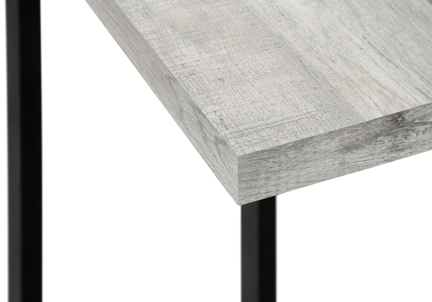 Closeup of distressed grey wood laminate desk surface with black metal leg