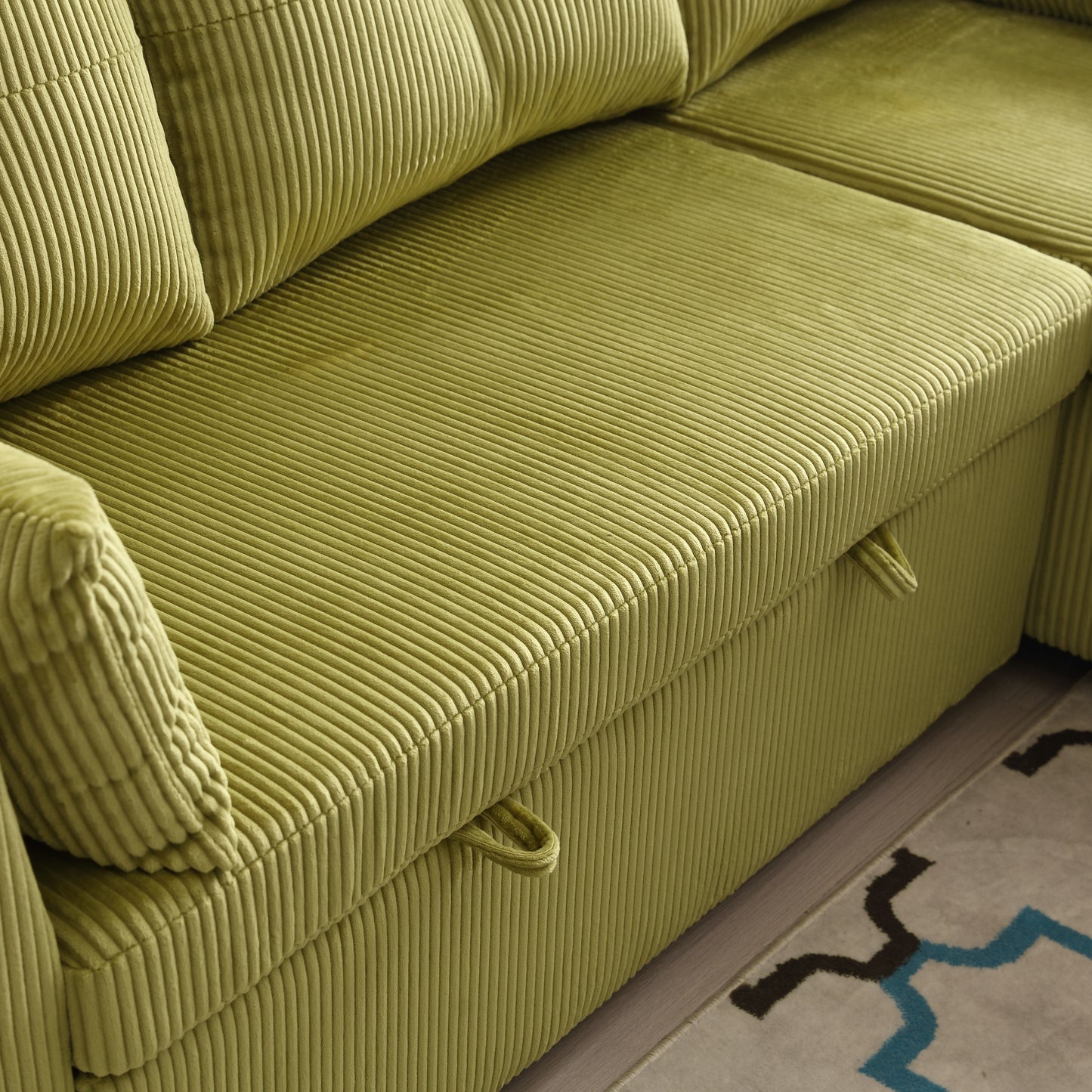 Closeup of a plush lime green corduroy sofa with hidden storage compartment
