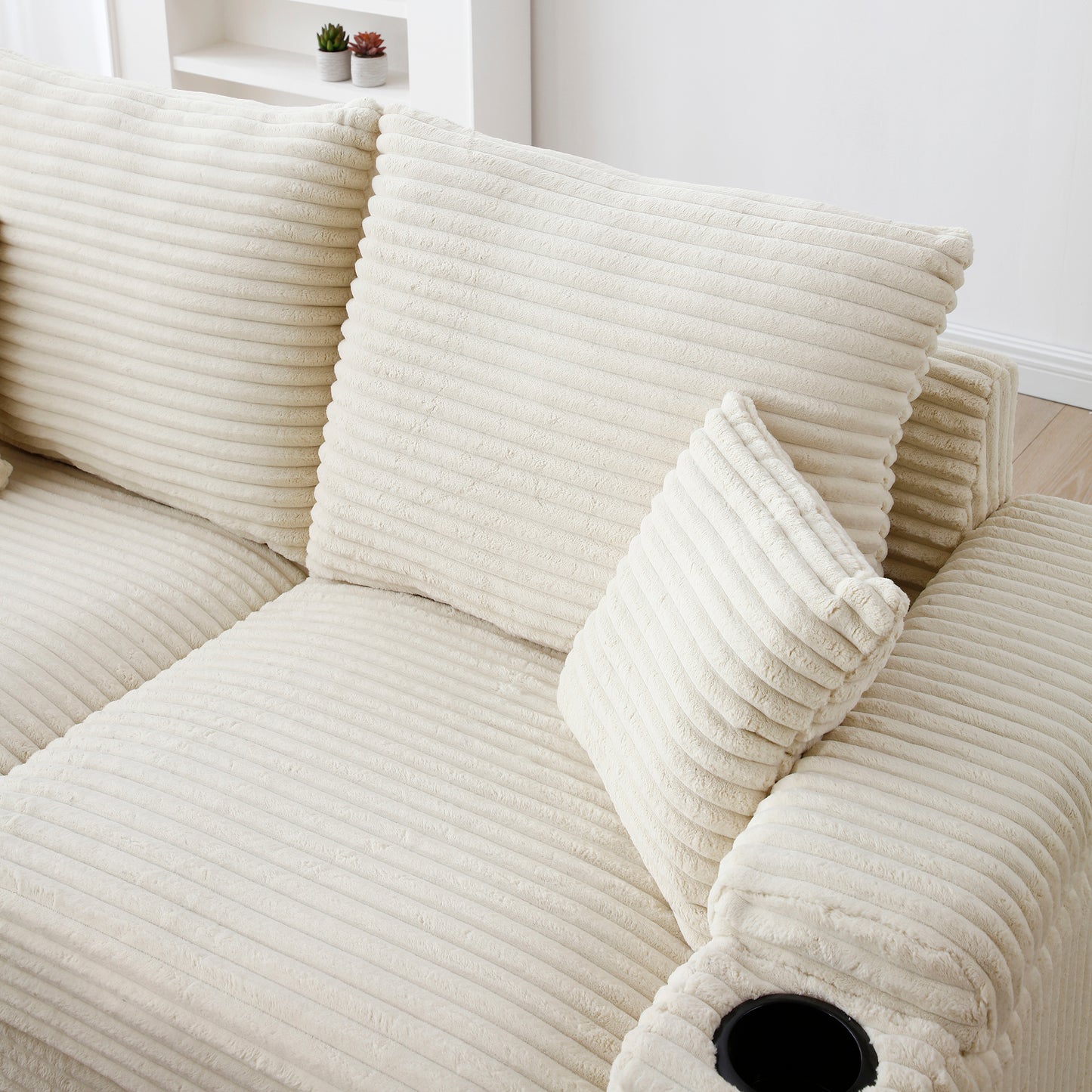 Cream corduroy sectional sofa with plush cushions and builtin cup holder