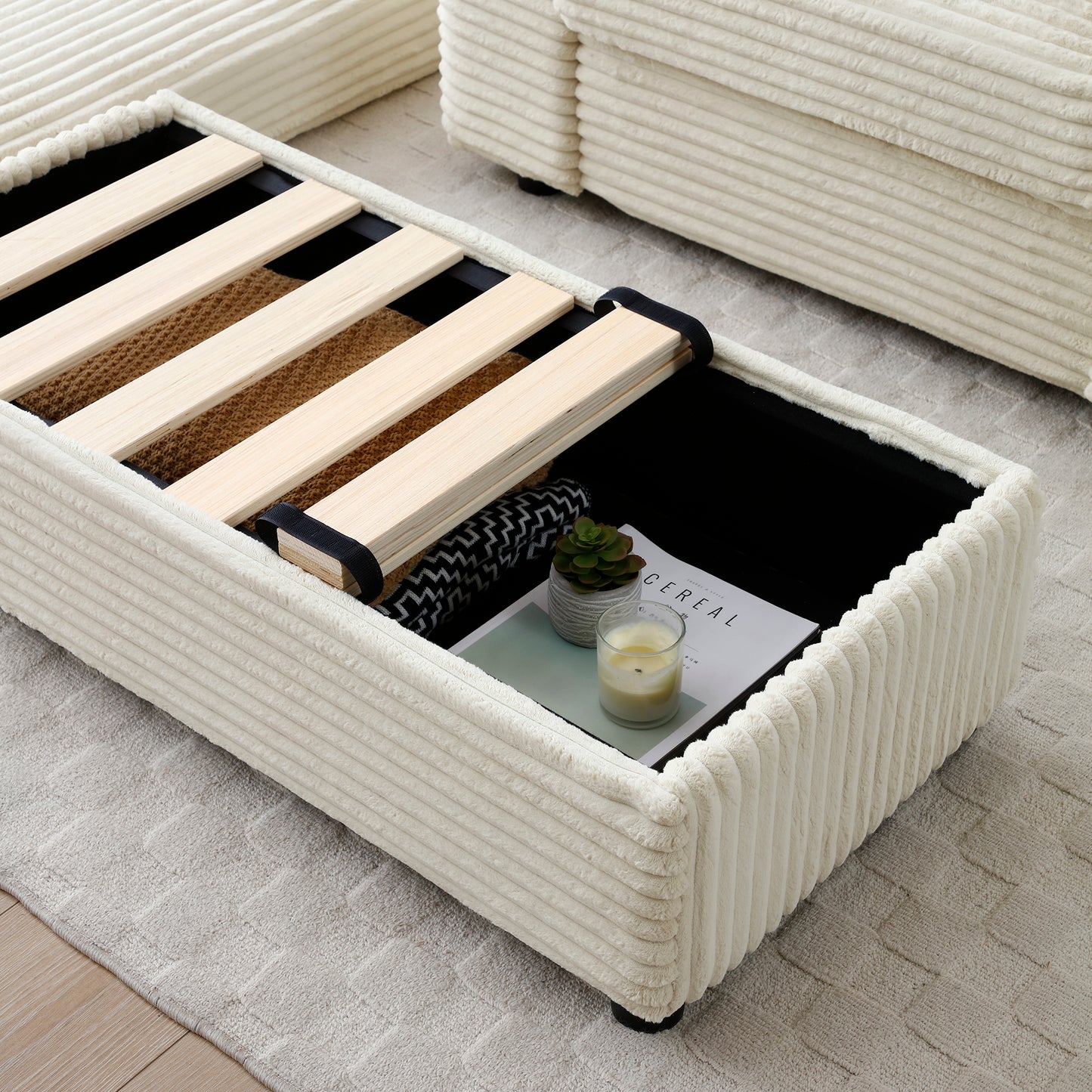 Cream corduroy storage ottoman with open lid revealing wooden slats and interior storage