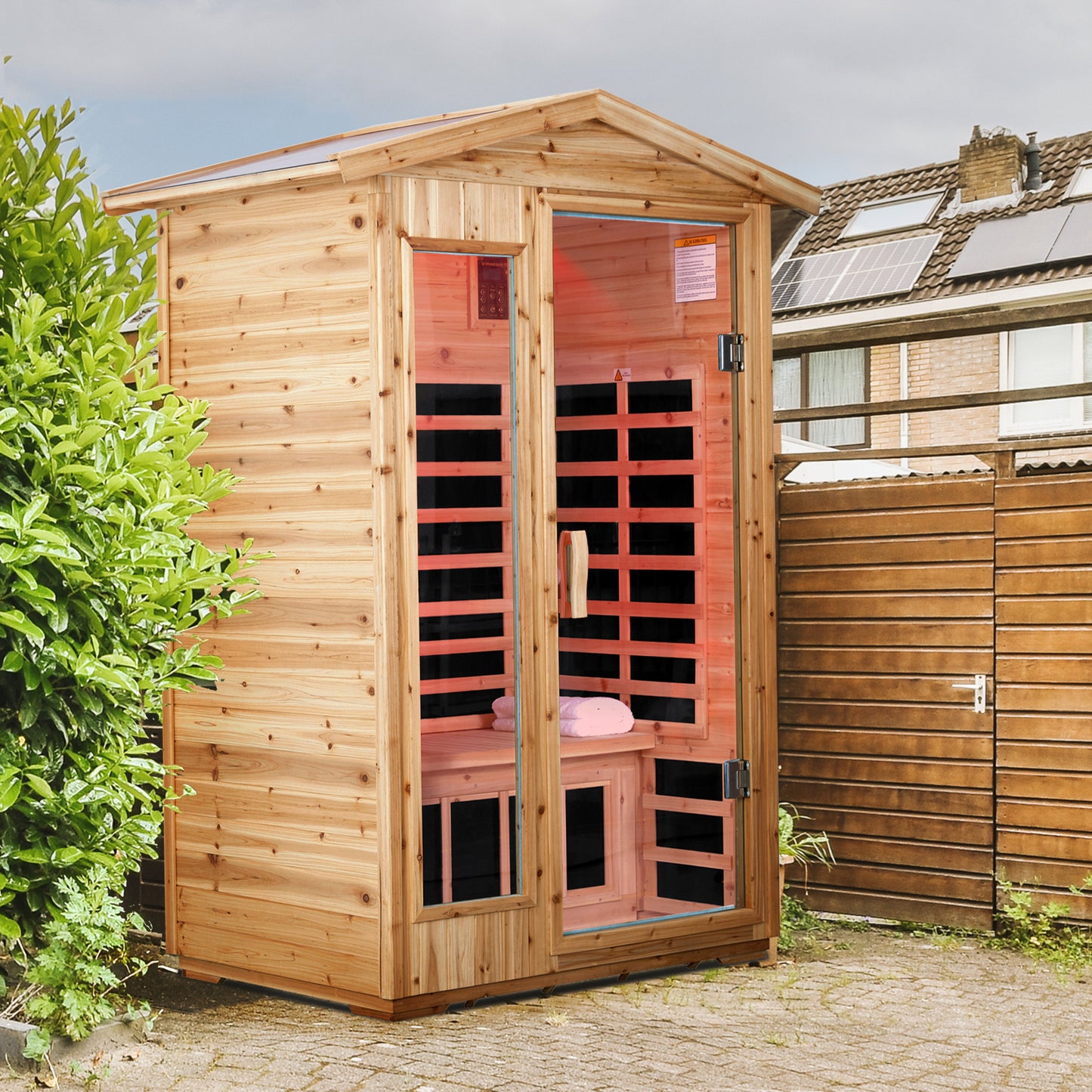Wooden infrared sauna cabin with glass doors and red heating panels for backyard relaxation