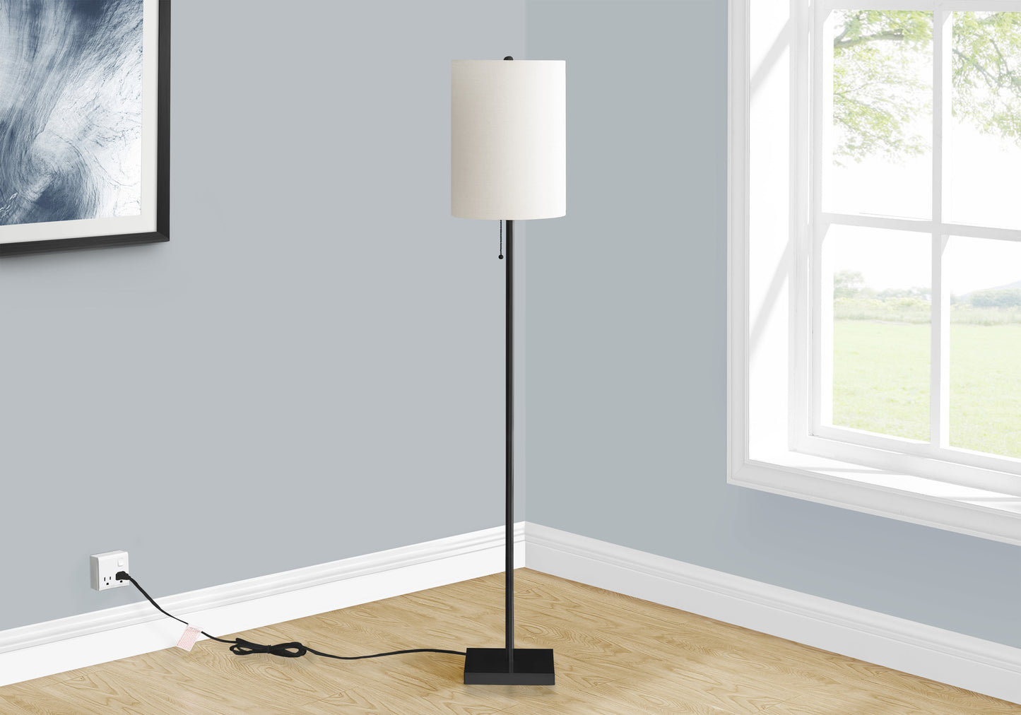 Modern black floor lamp with a white fabric drum shade and pull chain ideal for living rooms