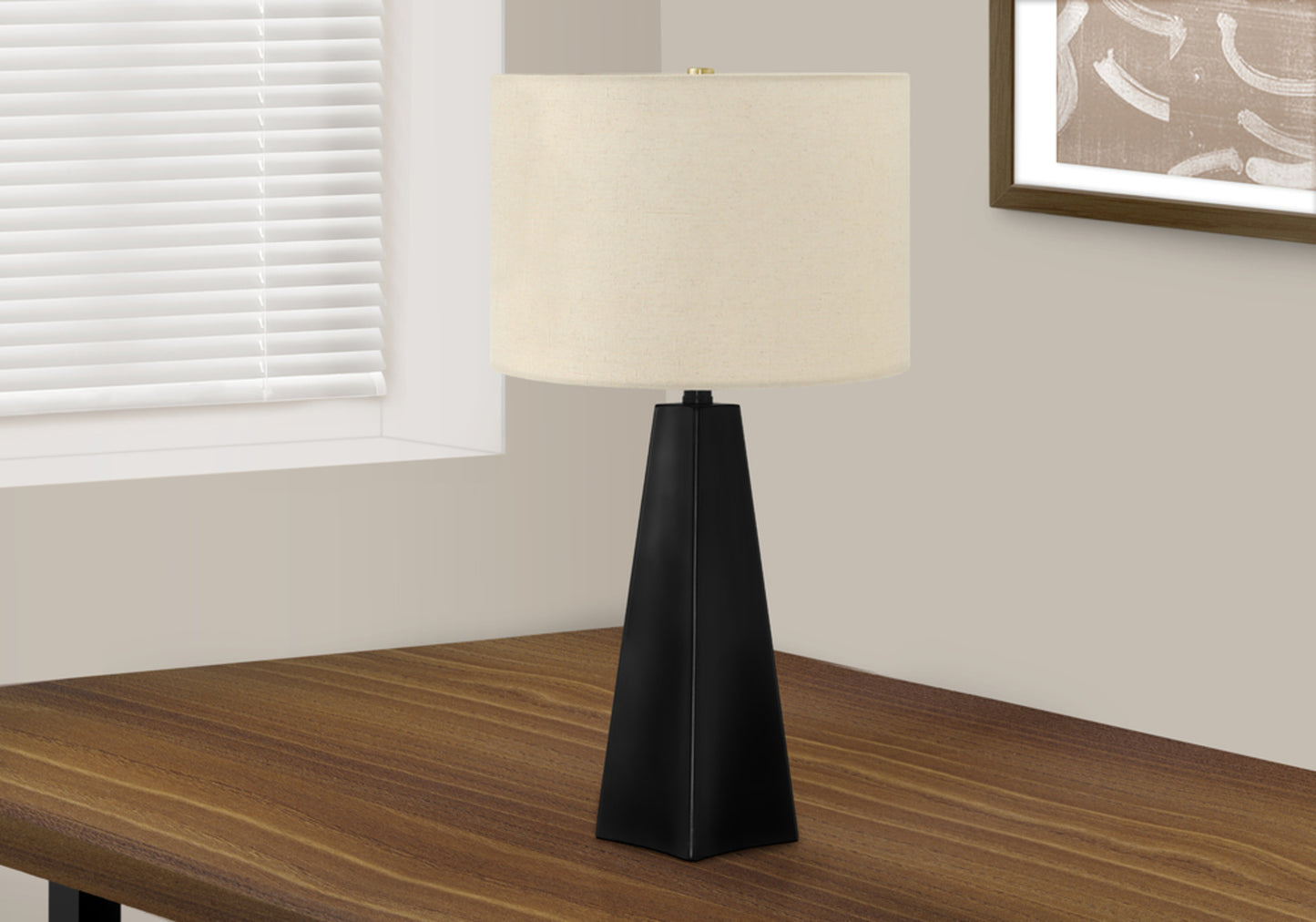 Modern black geometric table lamp with cream drum shade on wooden desk