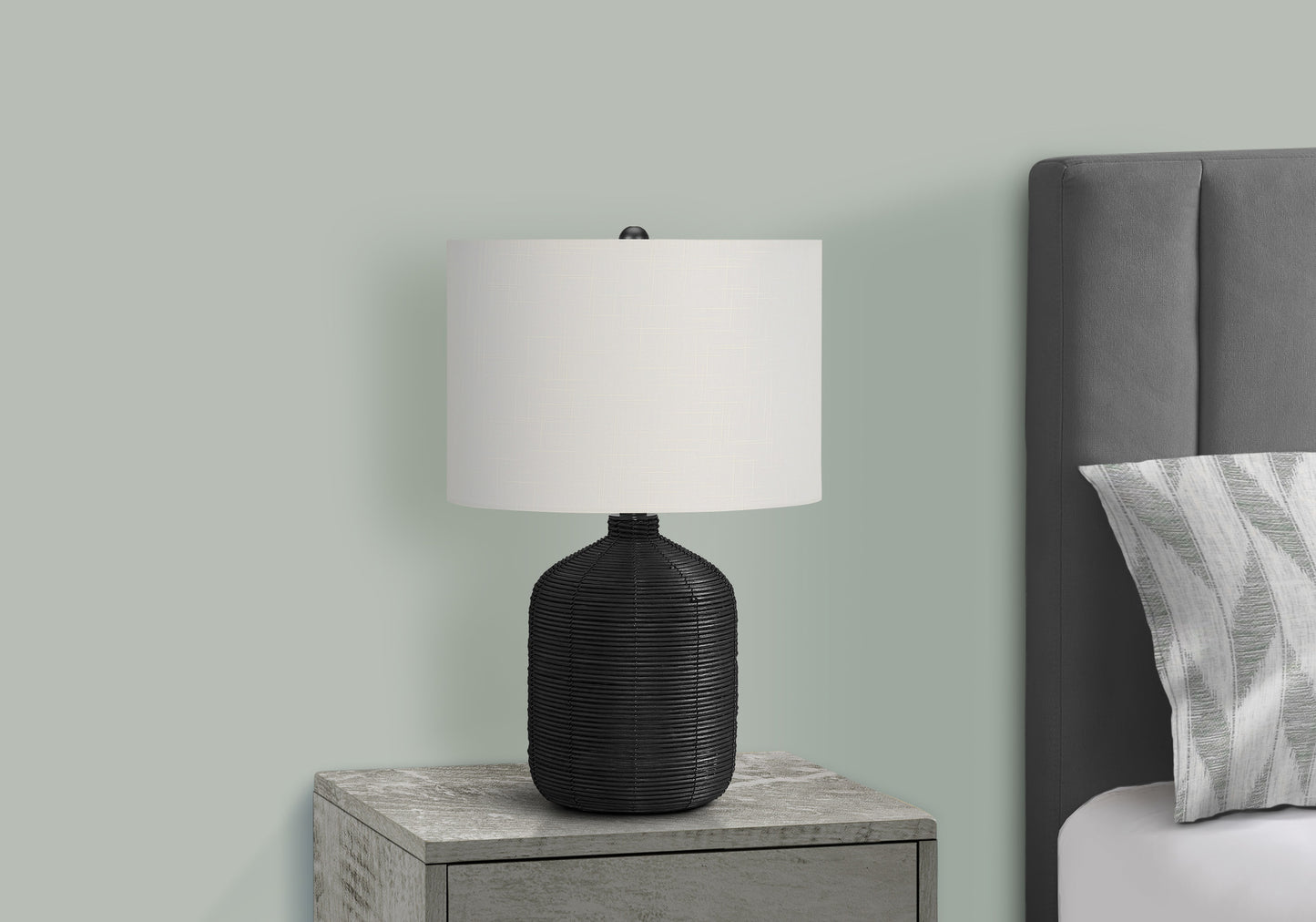 Black textured ceramic table lamp with a white linen shade on a gray nightstand