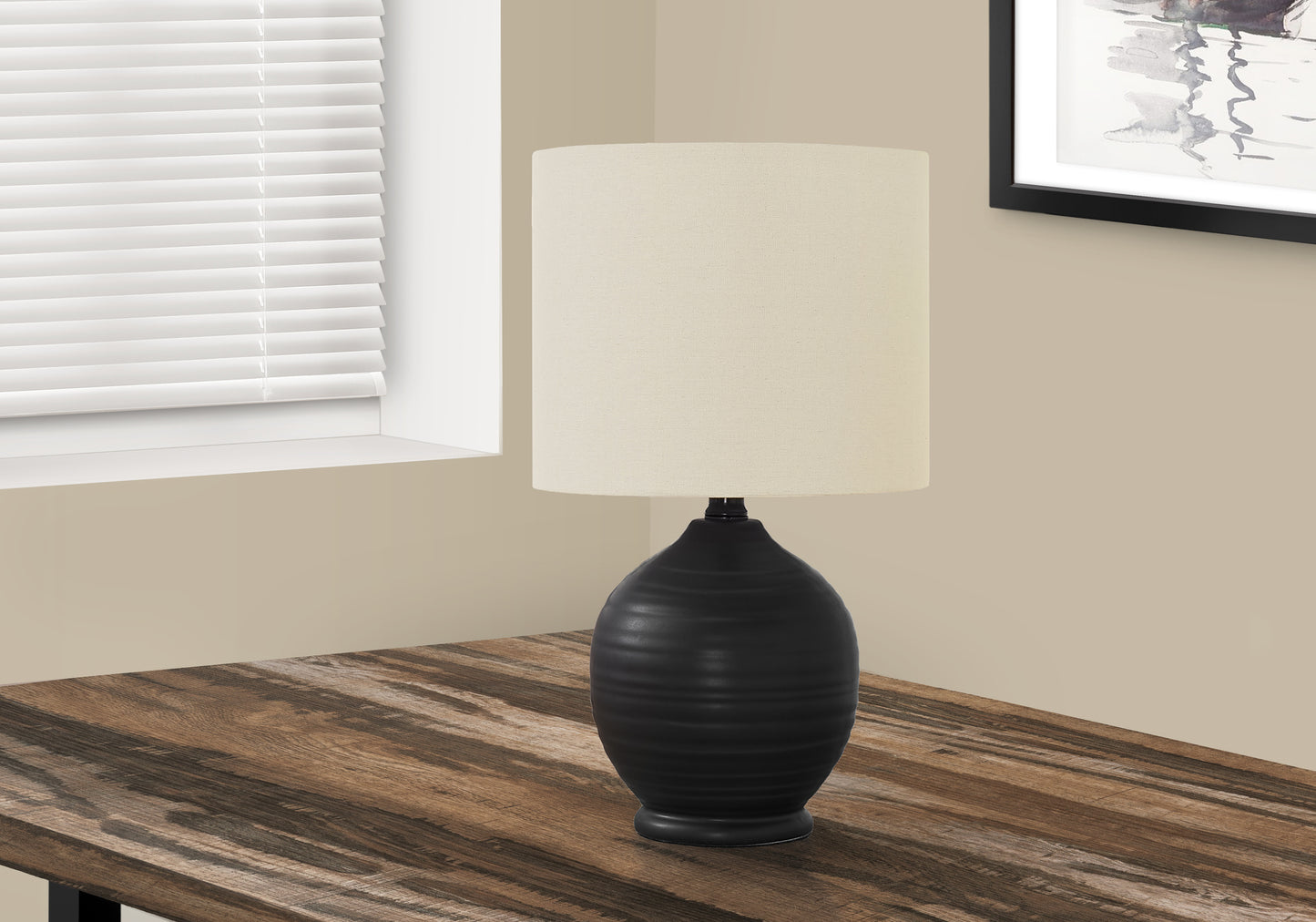 Black ceramic gourd table lamp with offwhite linen shade on wooden desk