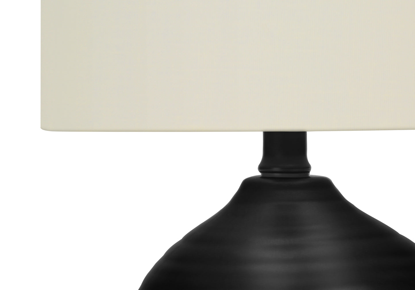 Closeup of black metal table lamp base with ivory shade