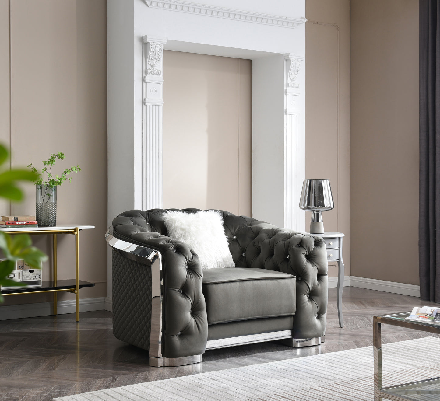 Dark grey velvet armchair with tufted design and chrome accents
