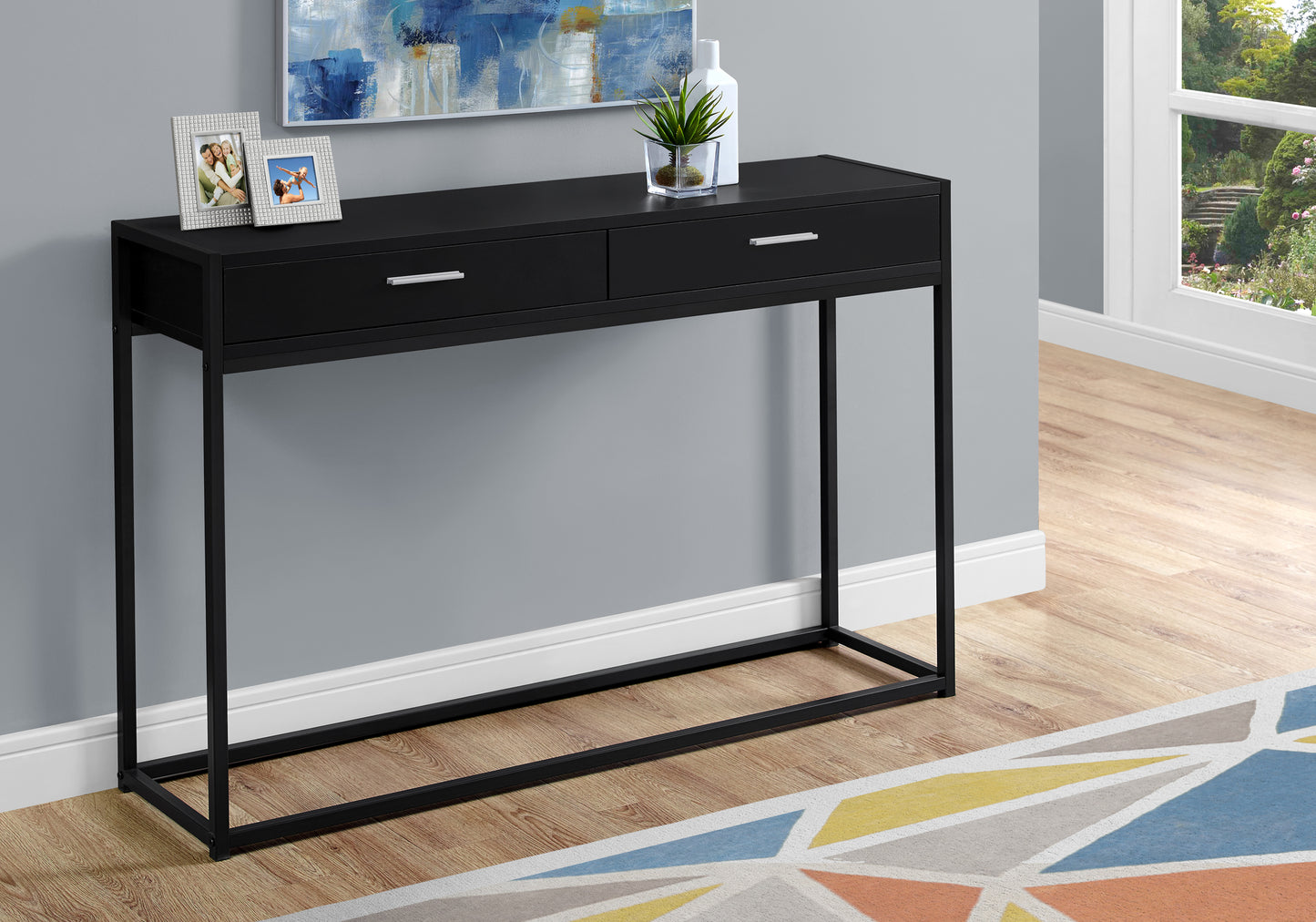 Sleek black twodrawer console table with slim metal legs perfect for entryways
