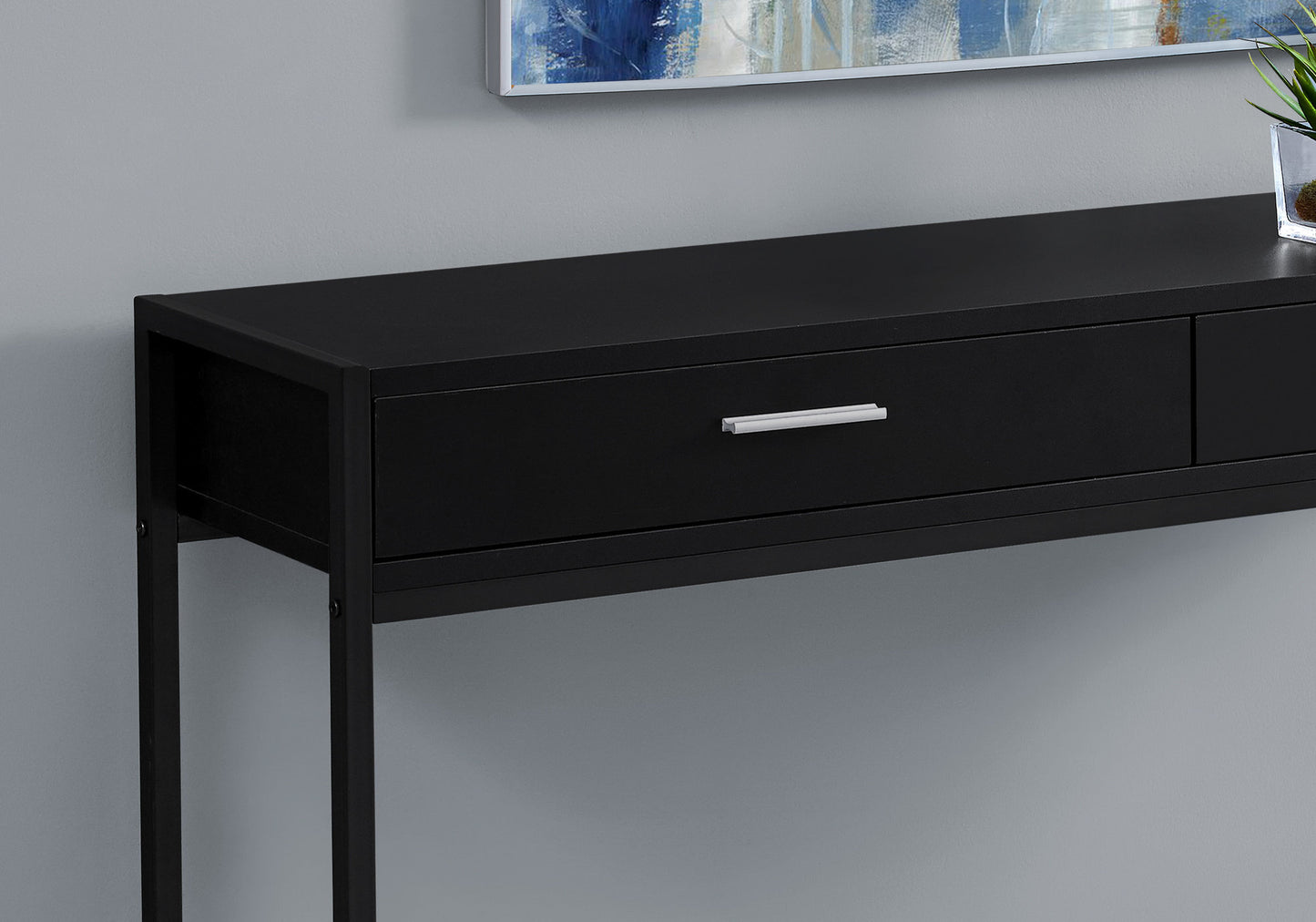 Sleek black entryway console table with a single drawer and silver handle