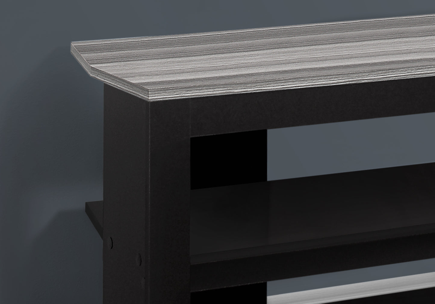 Black media console with grey driftwood top surface and open shelves