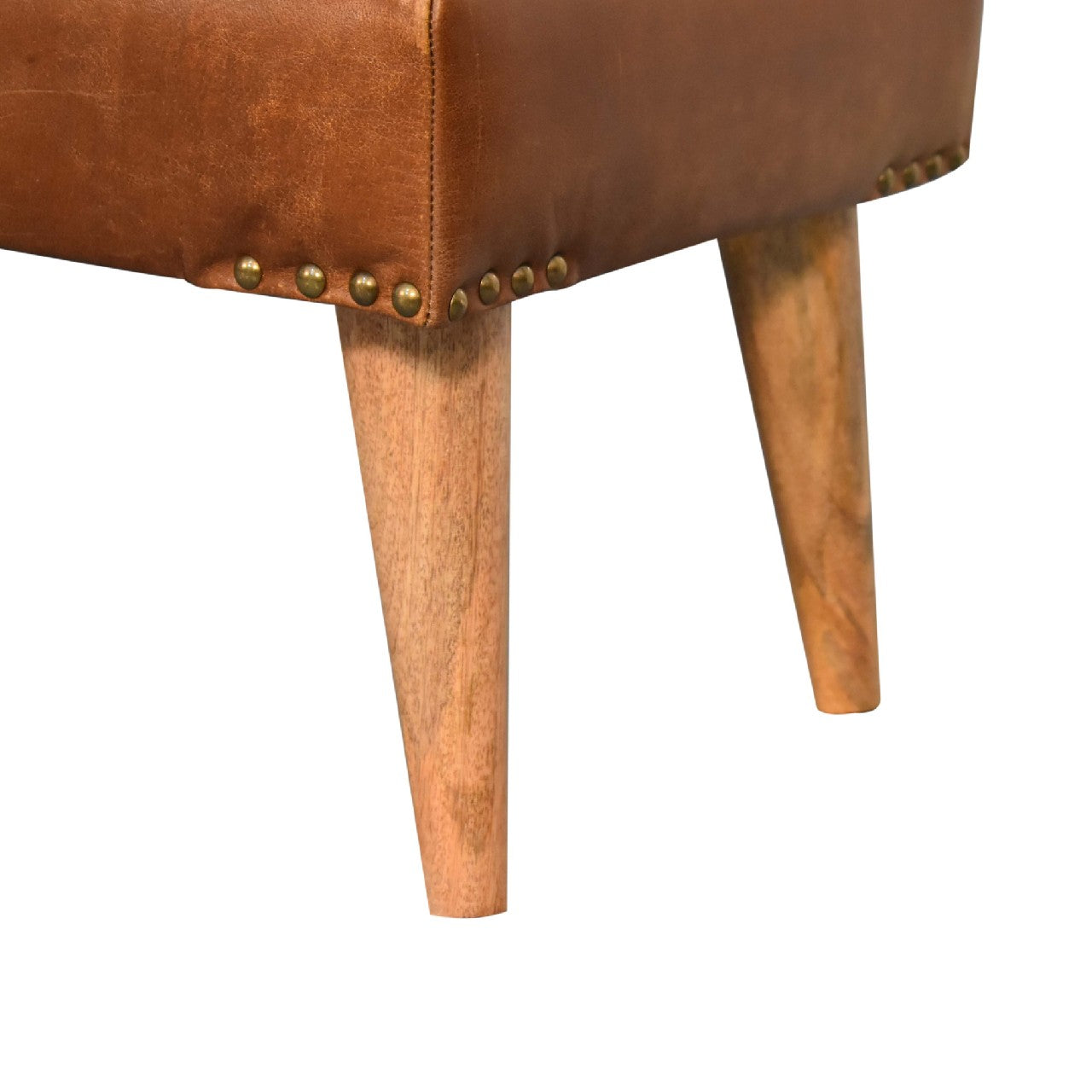 Brown leather ottoman with brass tack accents and tapered wooden legs