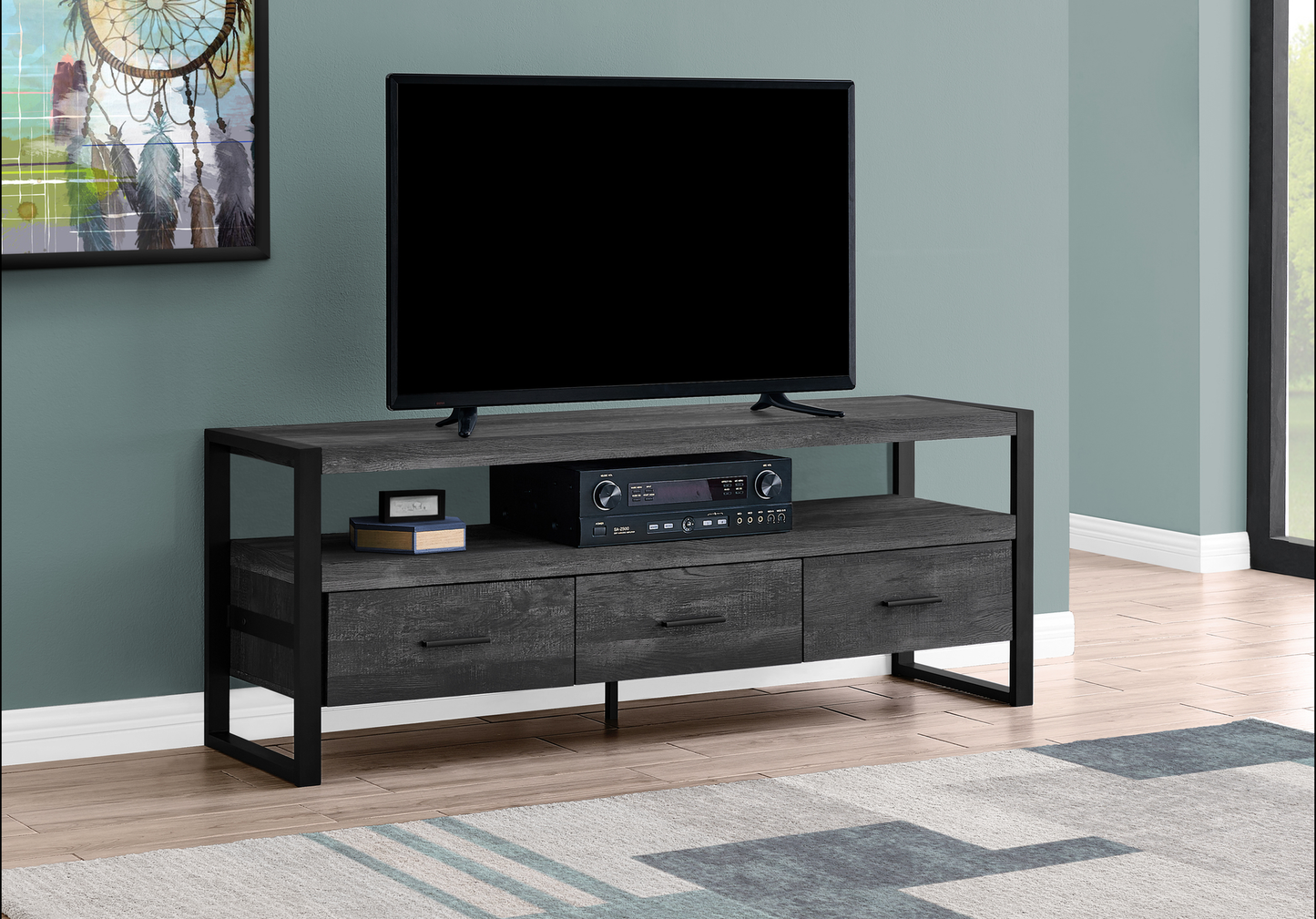 Gray wash wood TV stand with black metal frame and three drawers for media storage