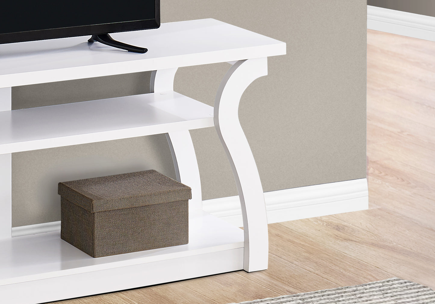 Modern white TV stand with curved legs and multiple shelves perfect for living rooms