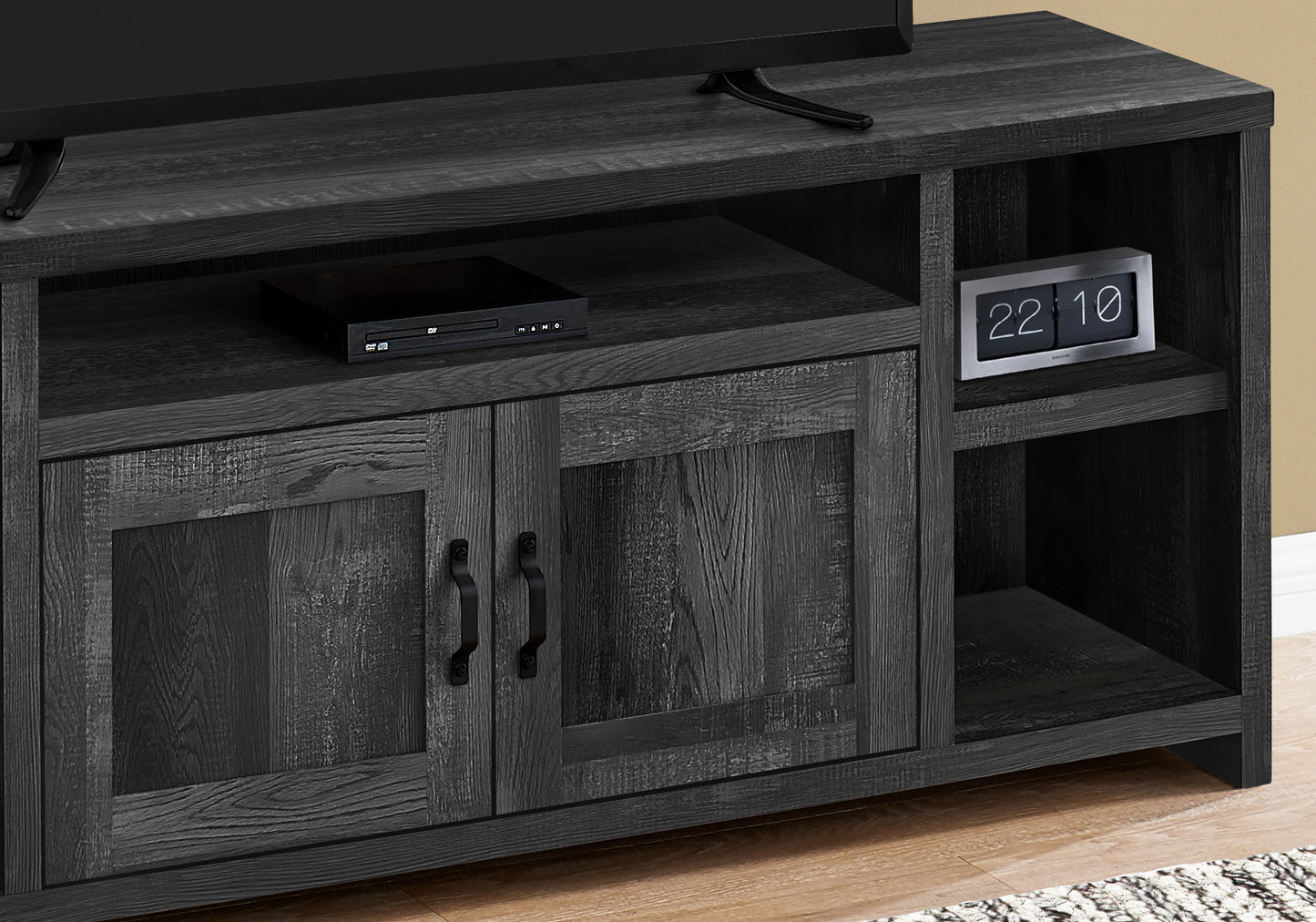 Dark grey wood grain TV stand with dual cabinet doors and open shelving for media console
