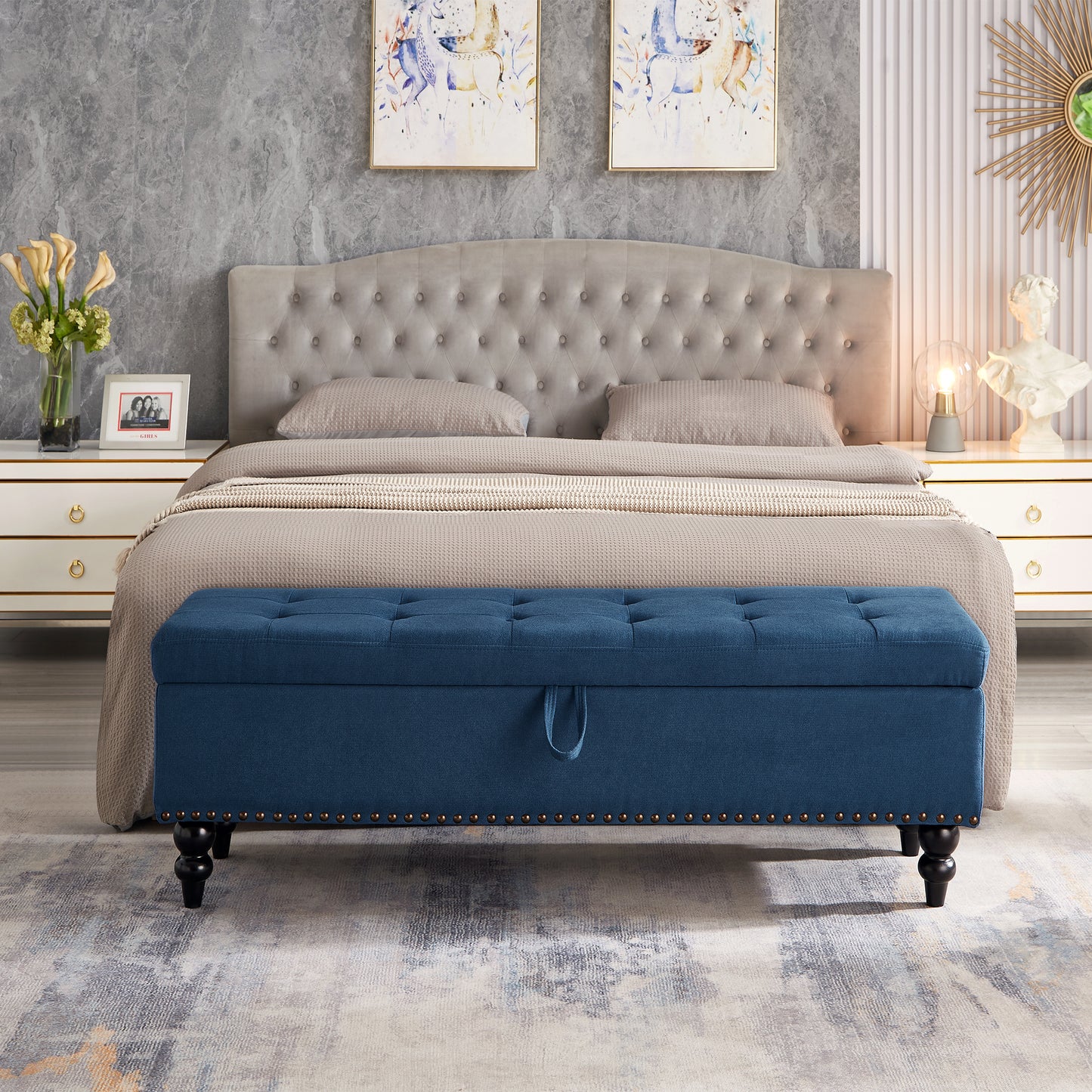 Tufted navy blue storage ottoman with brass nailhead trim