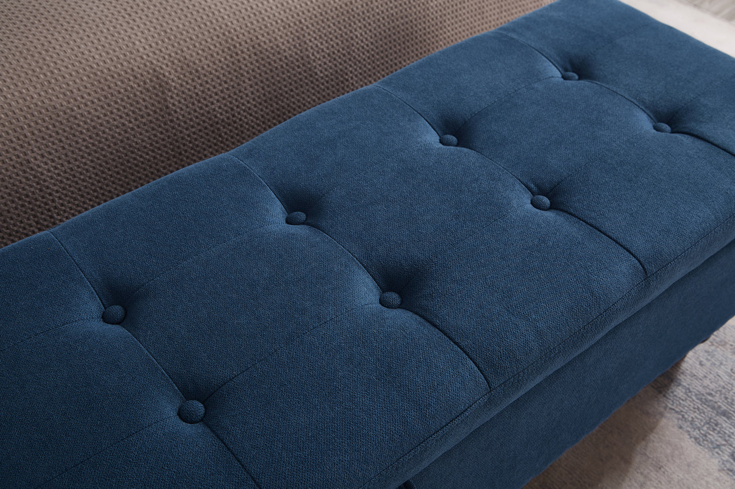 Deep navy storage ottoman with button tufting