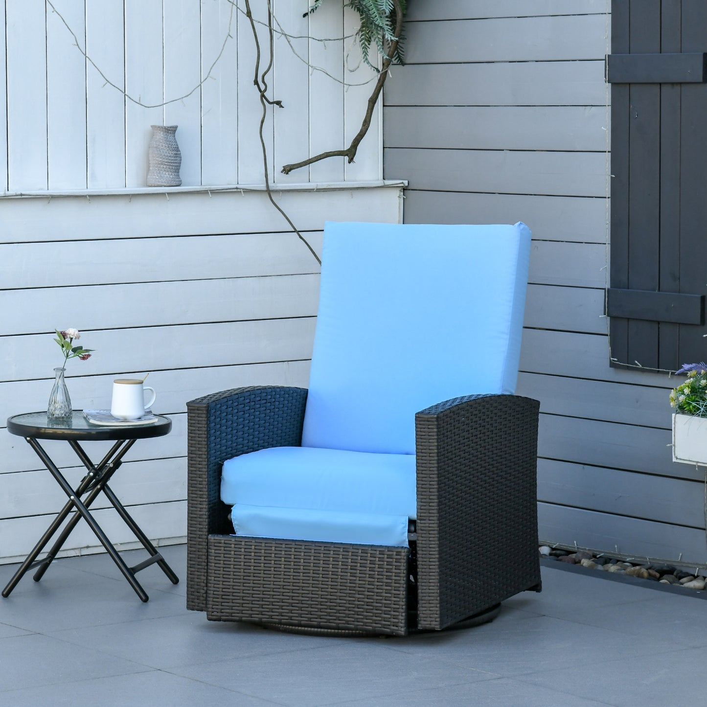 Dark brown wicker patio chair with plush light blue cushions perfect for outdoor relaxation