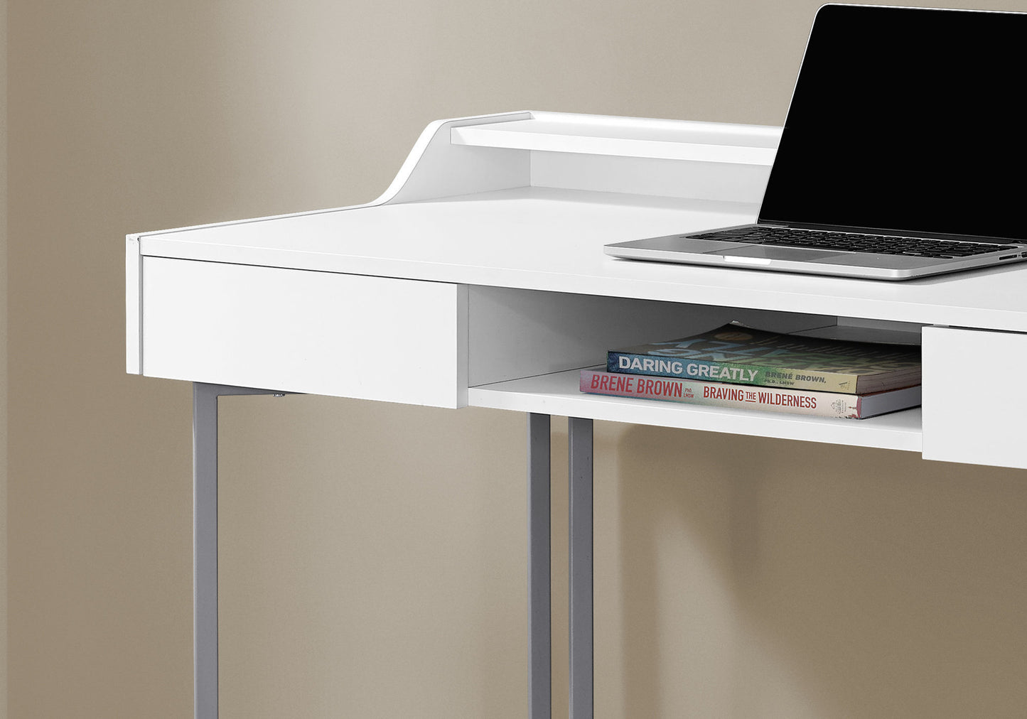 Modern white desk with sleek metal legs and a laptop