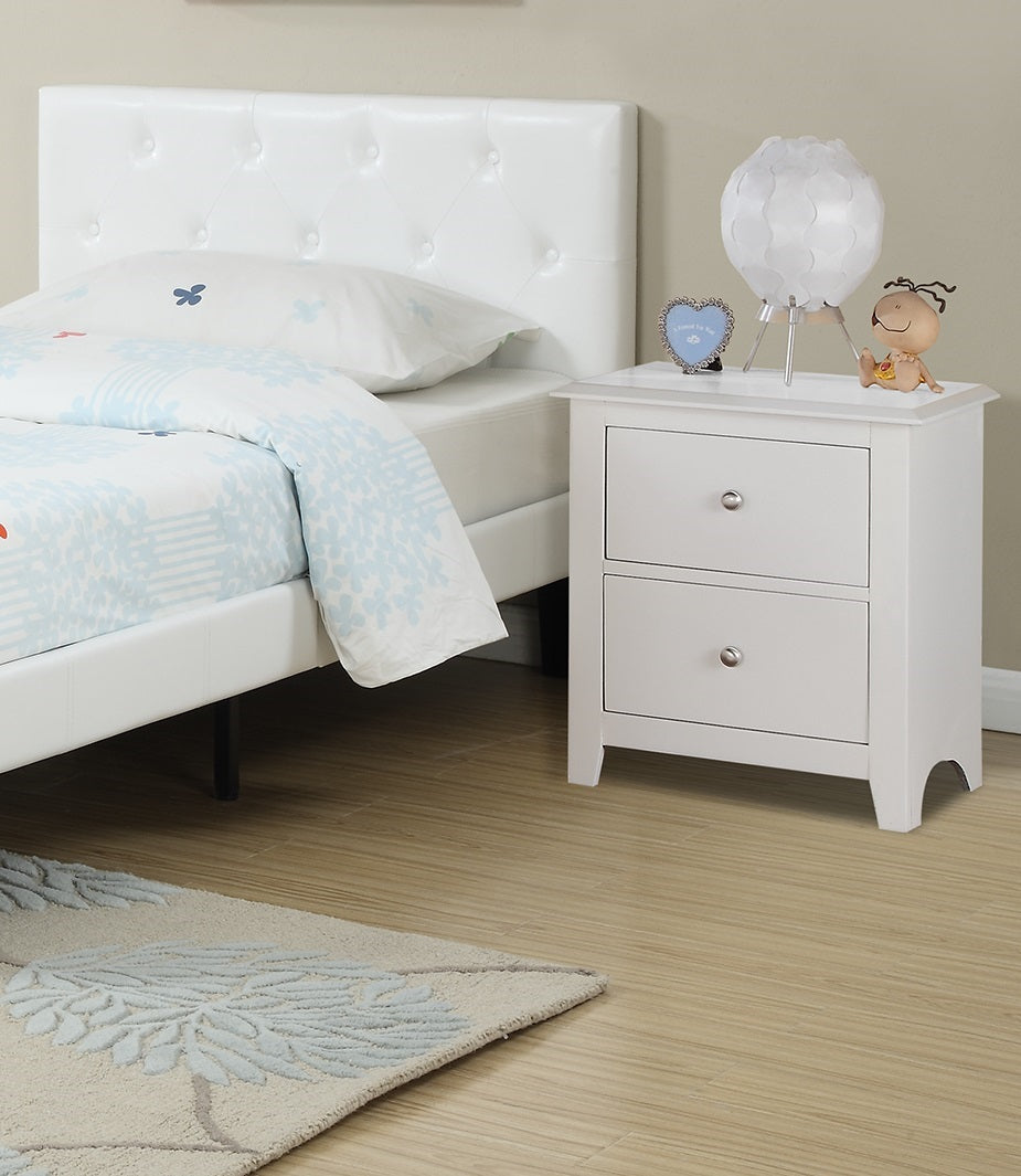 White faux leather tufted headboard with bedding and bedside table