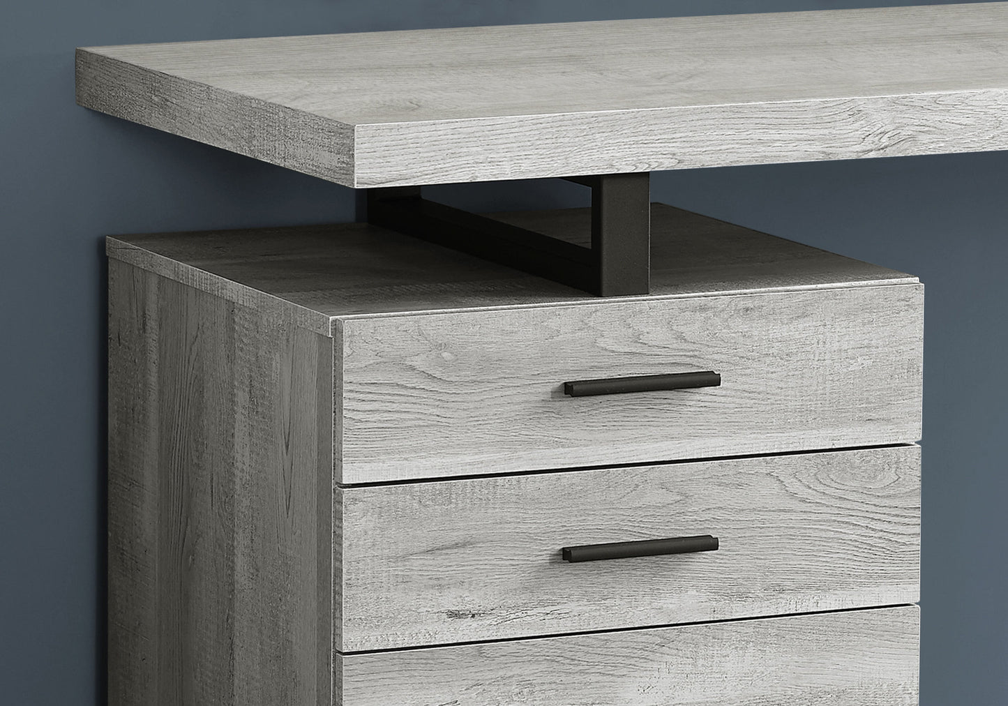 Grey wood grain desk with black metal accents and drawers