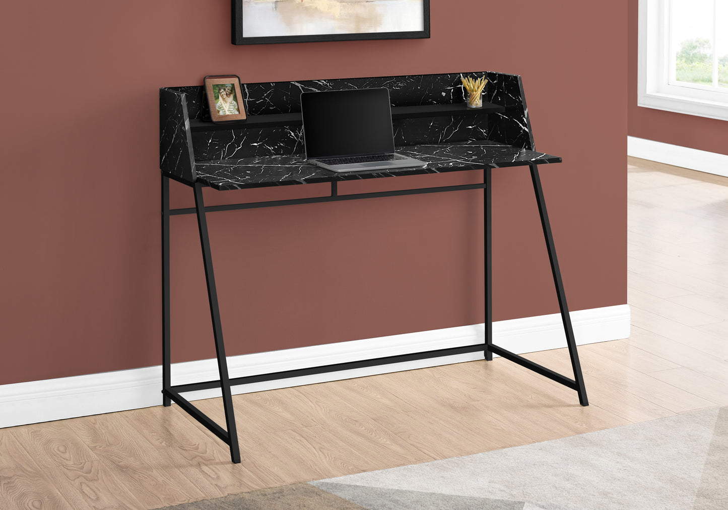 Modern black marble writing desk with a laptop and framed photo for elegant home office