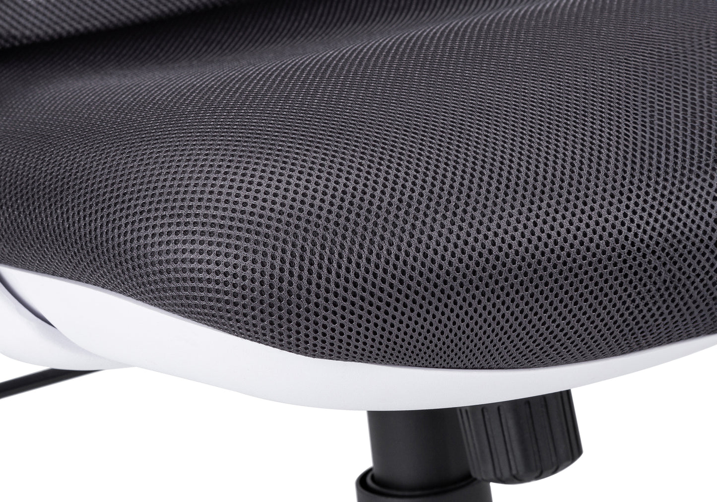 Closeup of dark grey mesh fabric on an ergonomic office chair seat