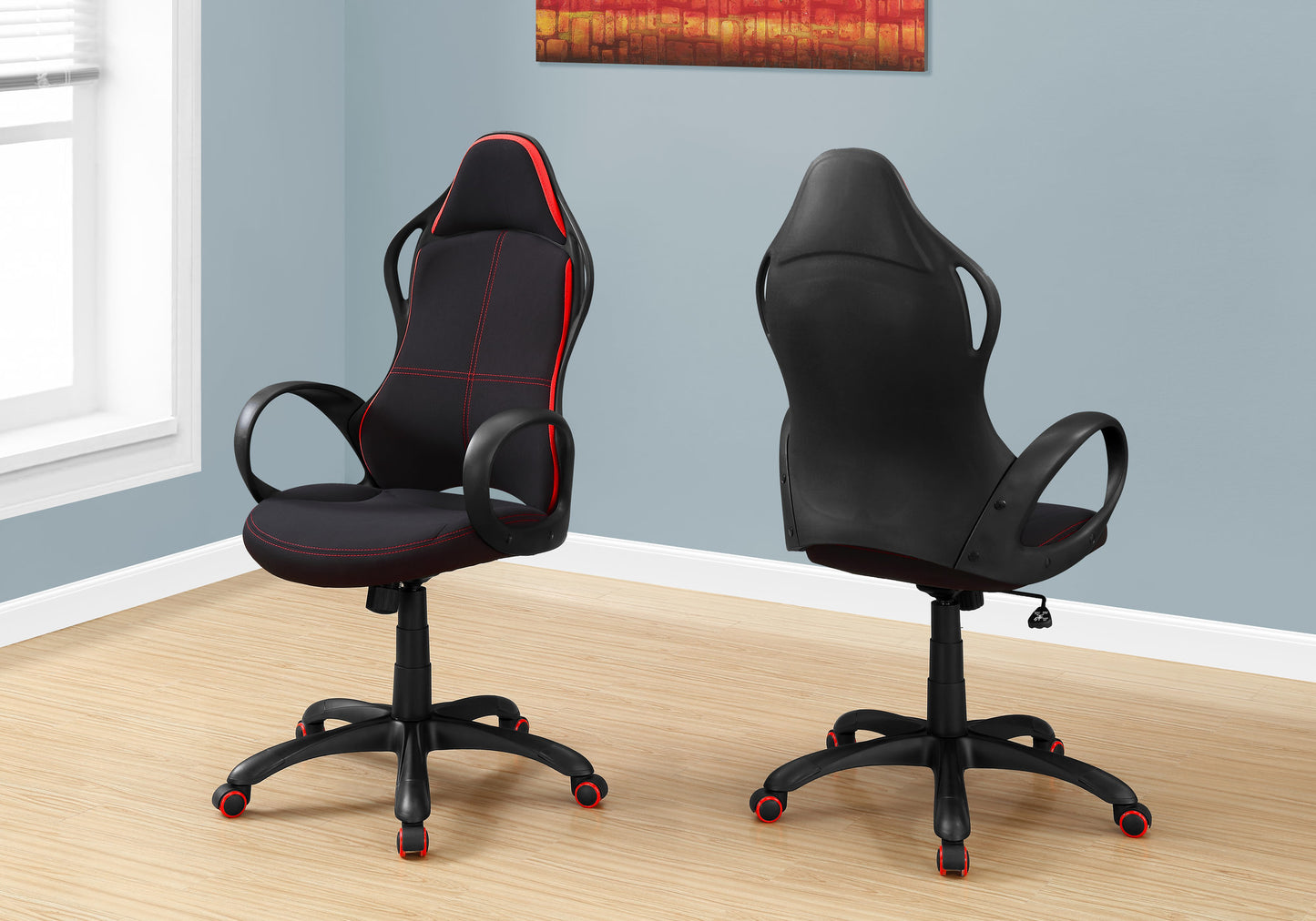 Black gaming chair with red stitching and accents