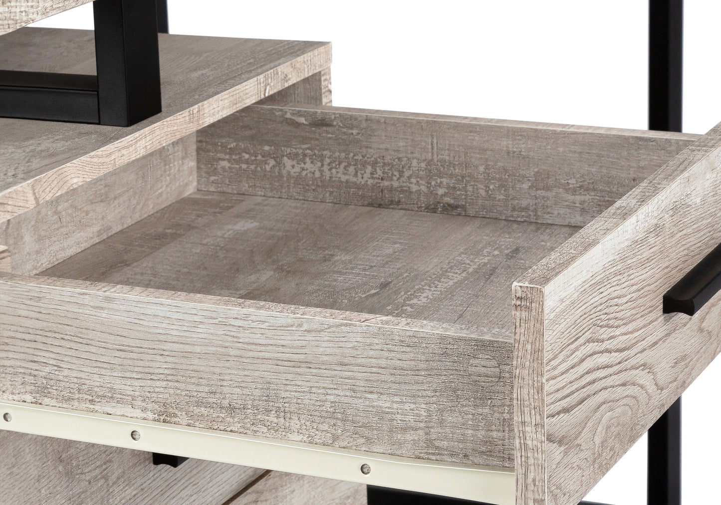 Open gray wood drawer with black hardware on rustic desk