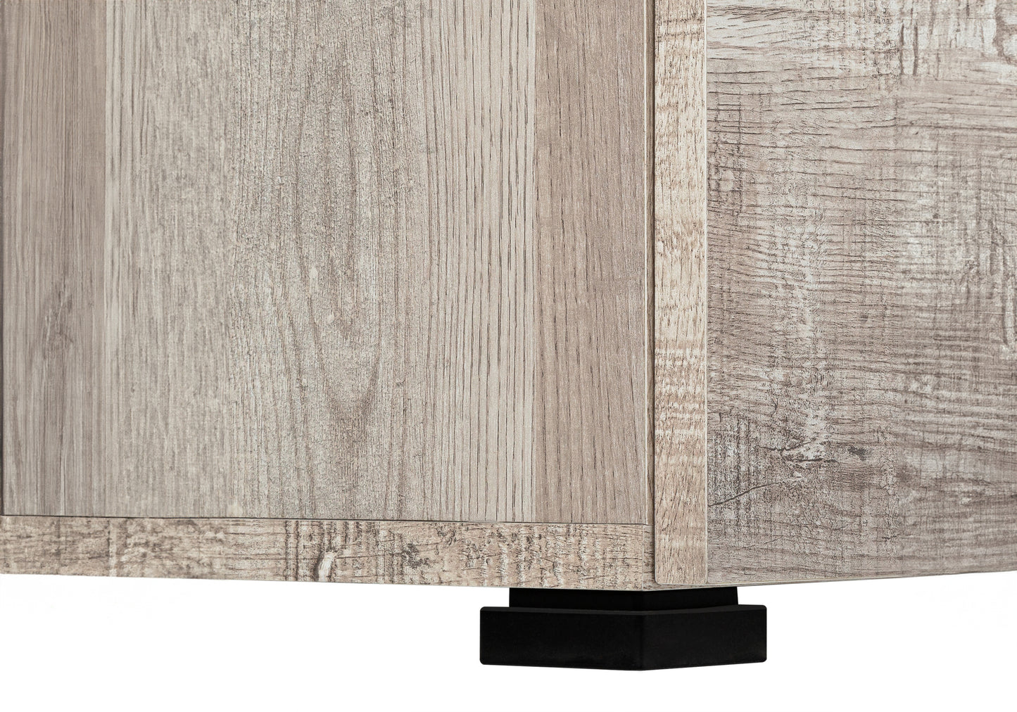 Closeup of a light brown woodgrain textured cabinet side panel with black base