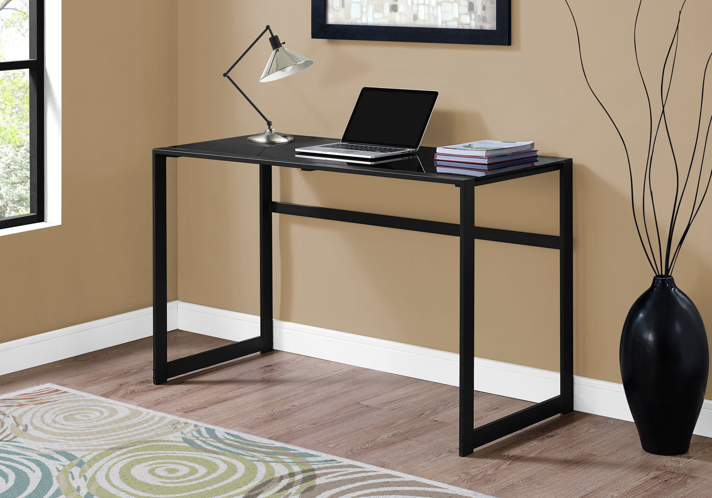 Sleek black glass desk with minimalist black metal frame perfect for home office productivity