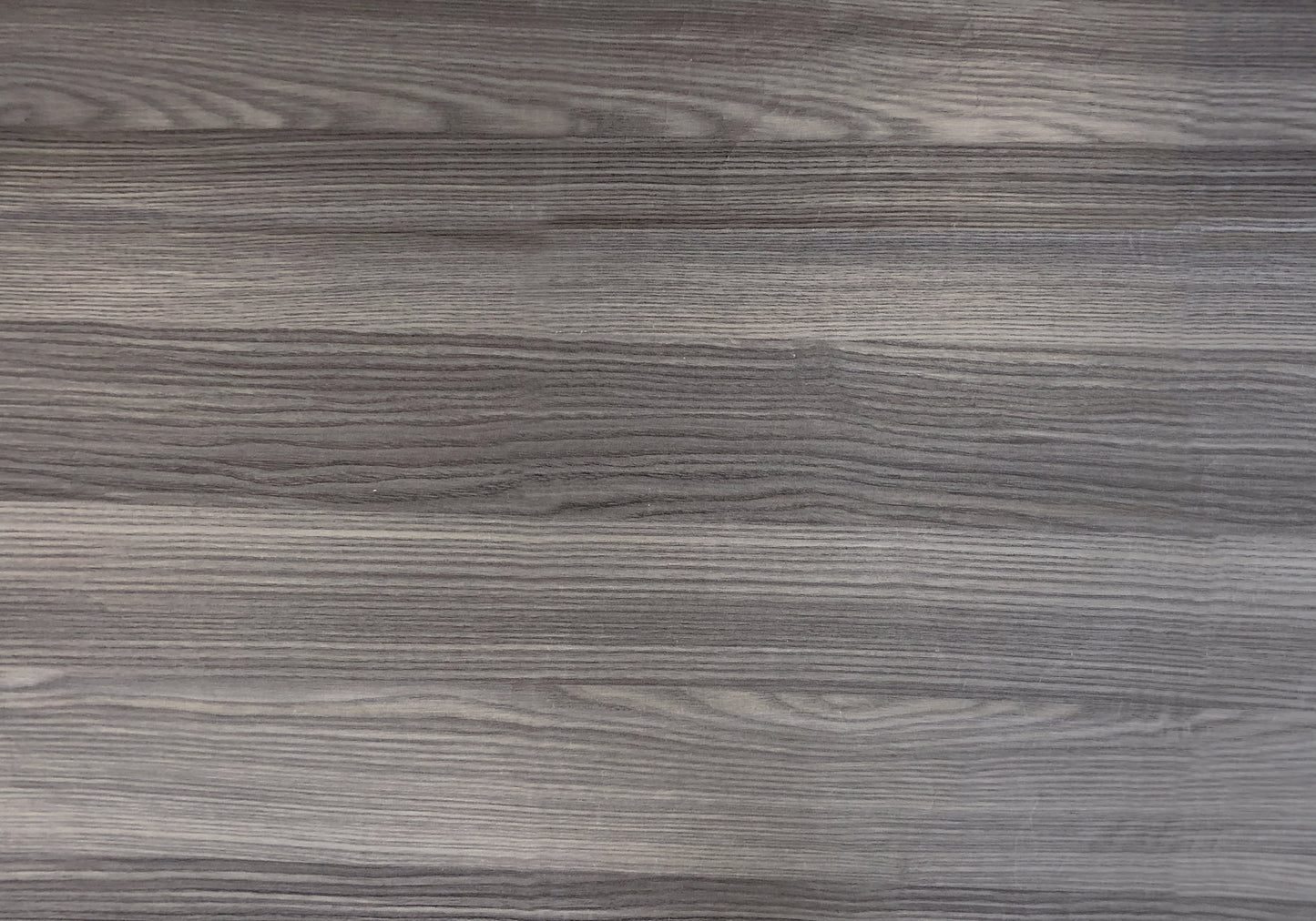 Distressed grey wood grain laminate surface with horizontal plank texture