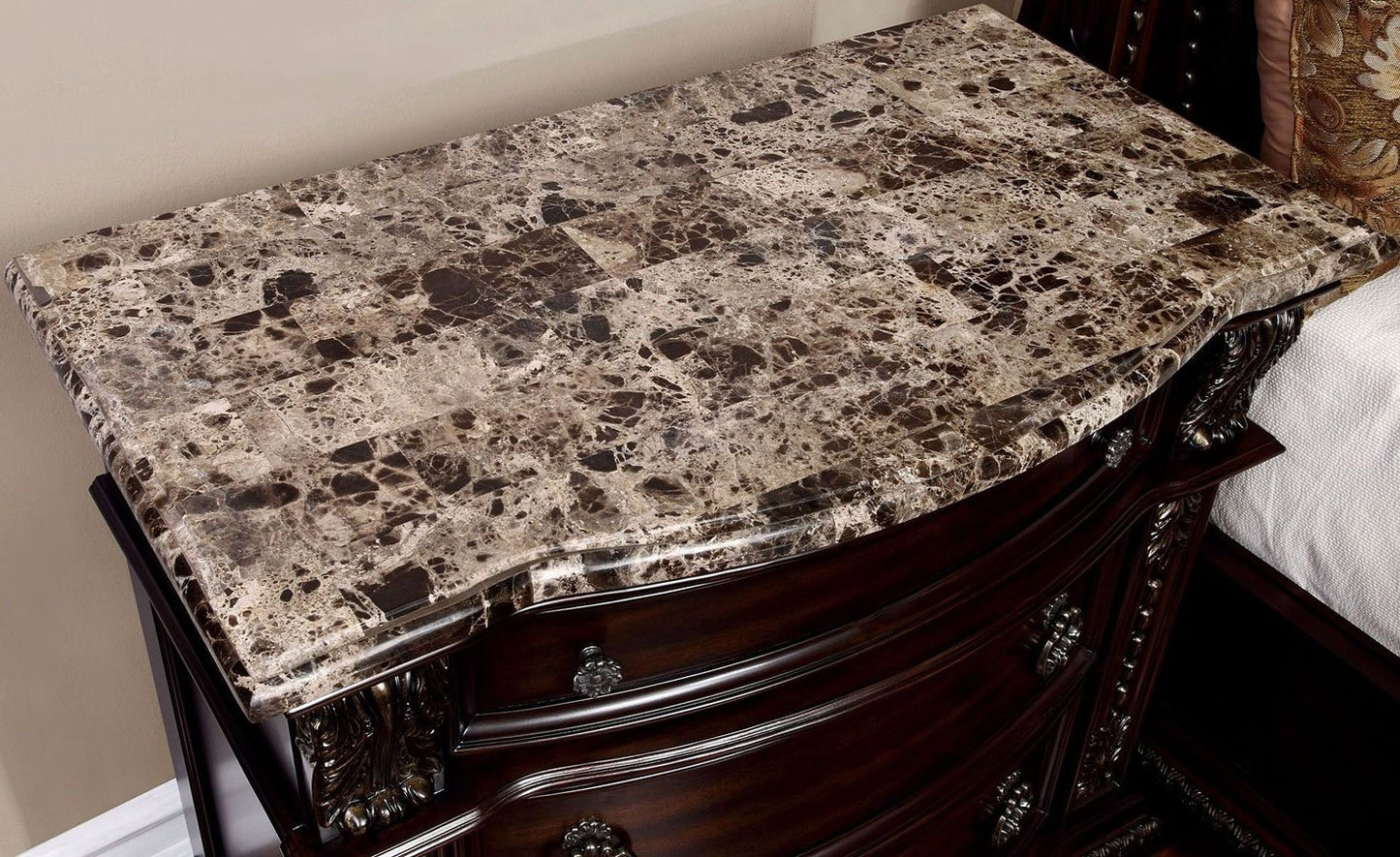 Dark wood dresser with ornate carved details and a striking marble top