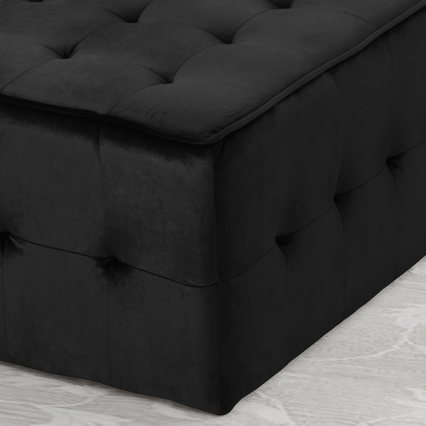 Black velvet storage ottoman with tufted lid and side accents
