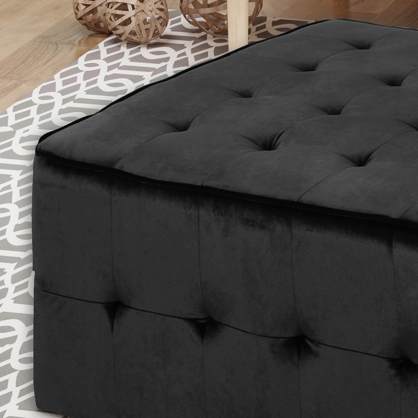 Black velvet tufted ottoman with clean lines