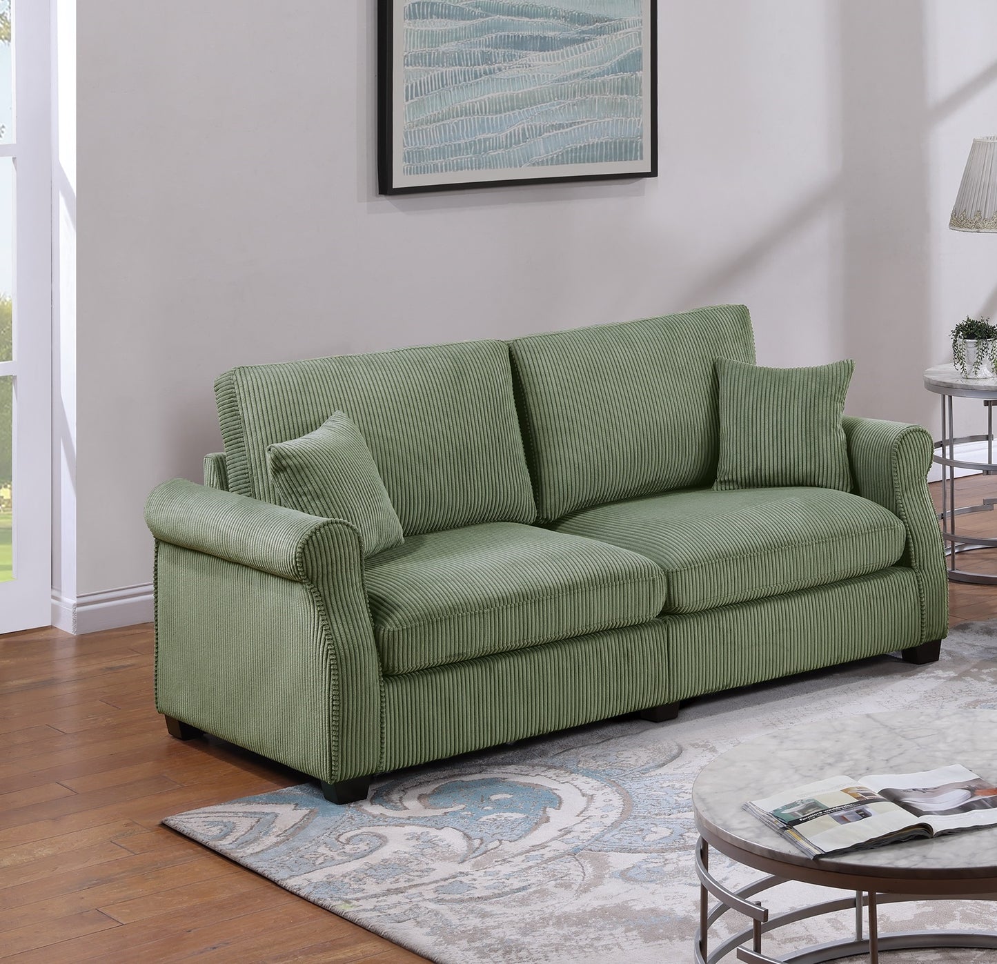 Sage green corduroy sofa with plush cushions and decorative piping perfect for living rooms