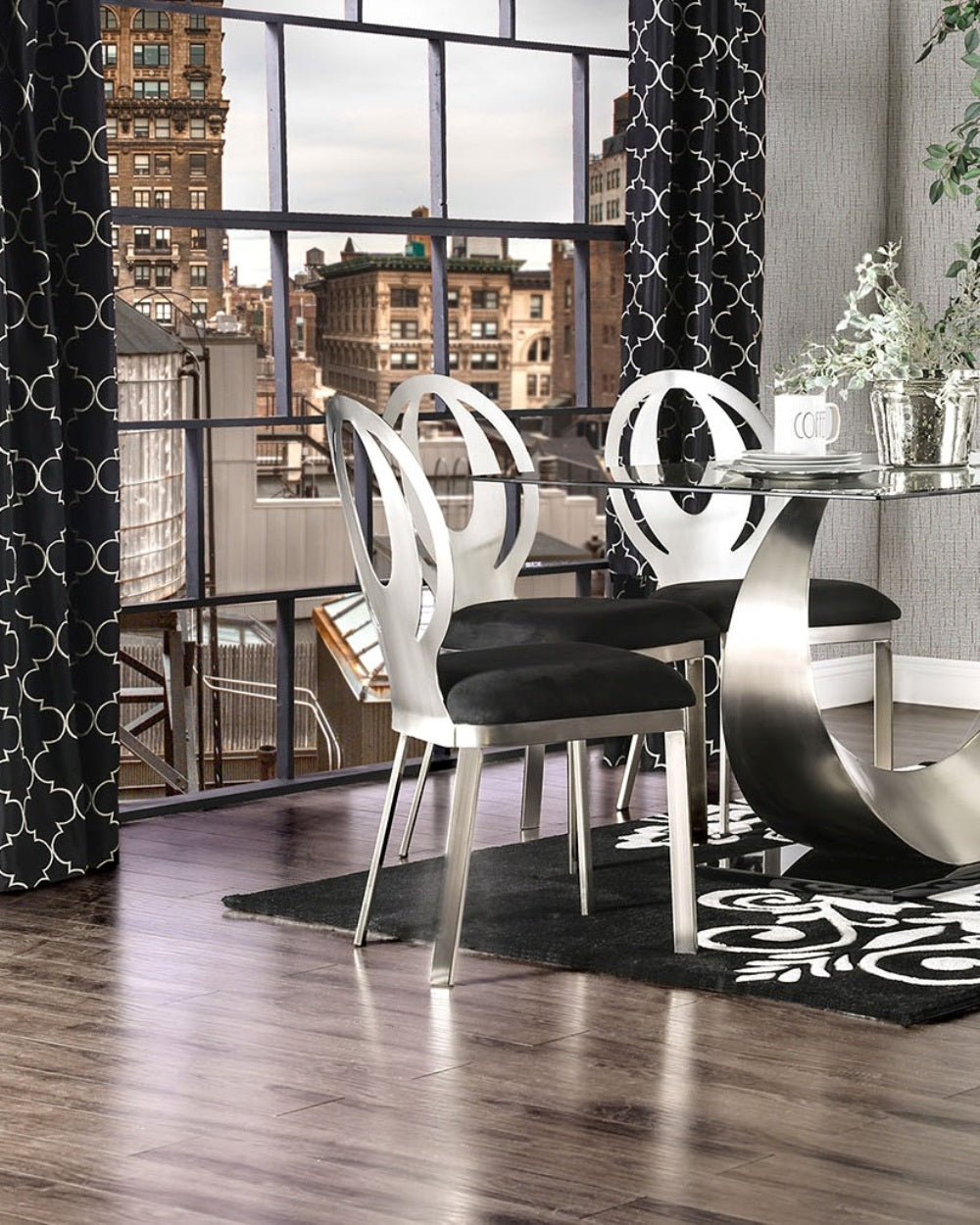 Two contemporary dining chairs with brushed silver frames and black velvet seats