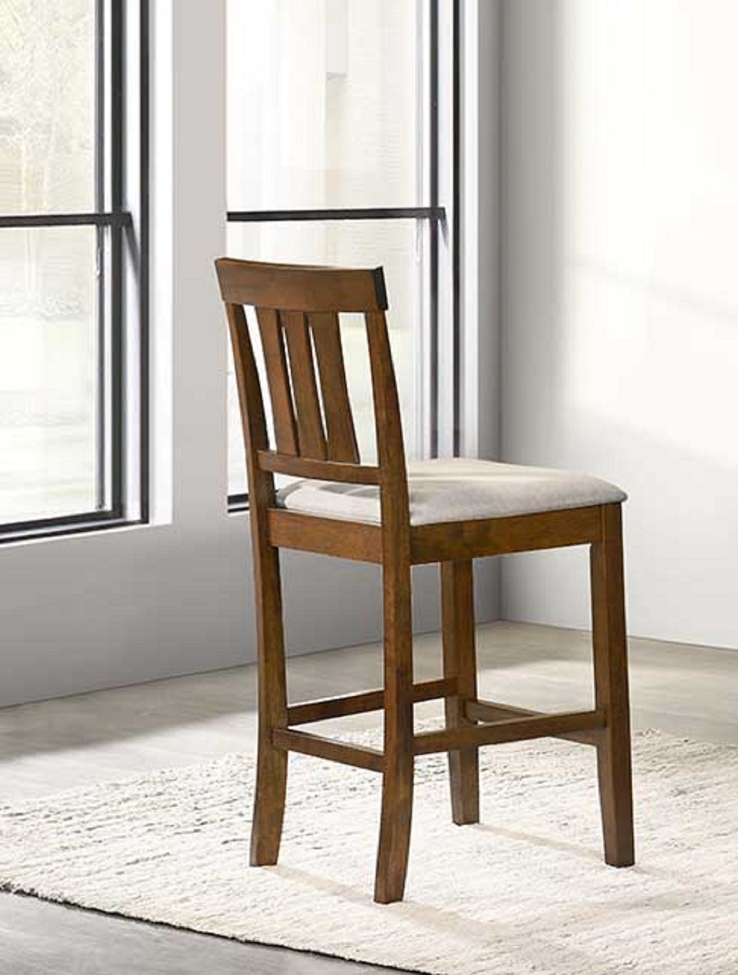 Classic wooden bar stool with a neutral upholstered seat and slatted back