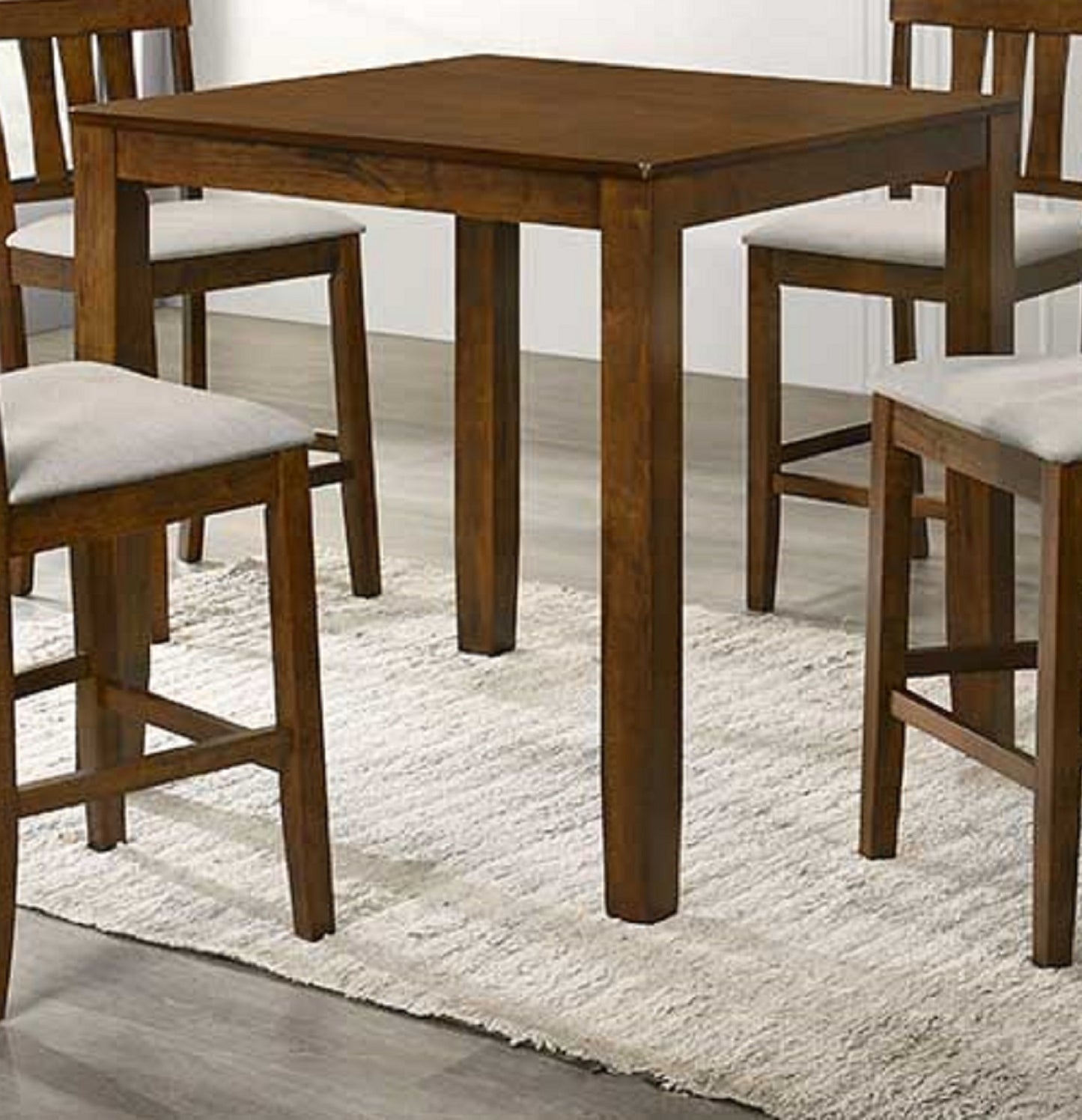 Dark wood bar table with four cushioned stools for a modern kitchen space