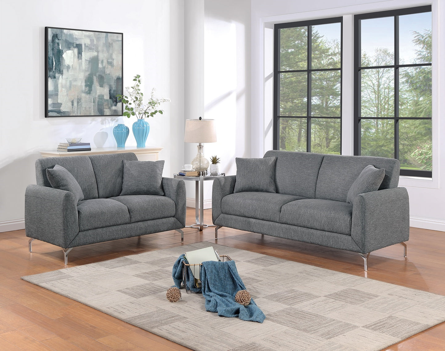 Two gray upholstered sofas with chrome legs in a modern living room