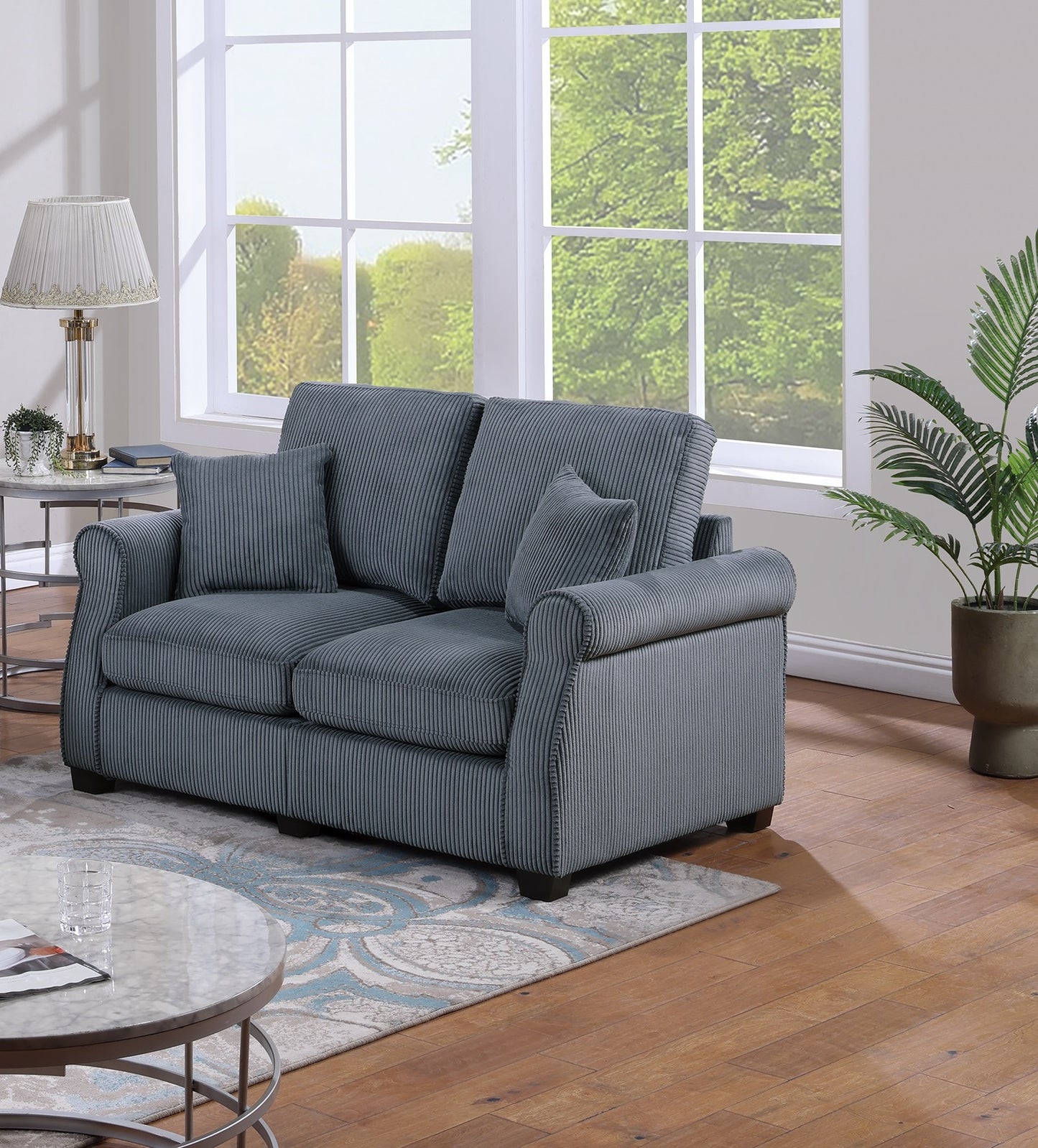 Dark gray corduroy loveseat with plush cushions and rolled arms