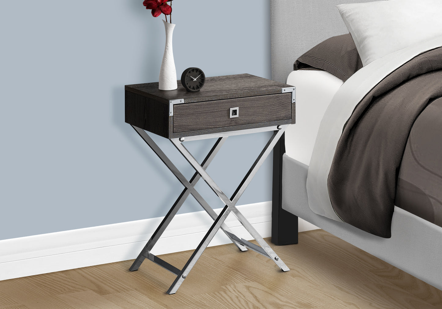 Dark wood accent table with chrome Xframe legs featuring a single drawer and decorative metal accents