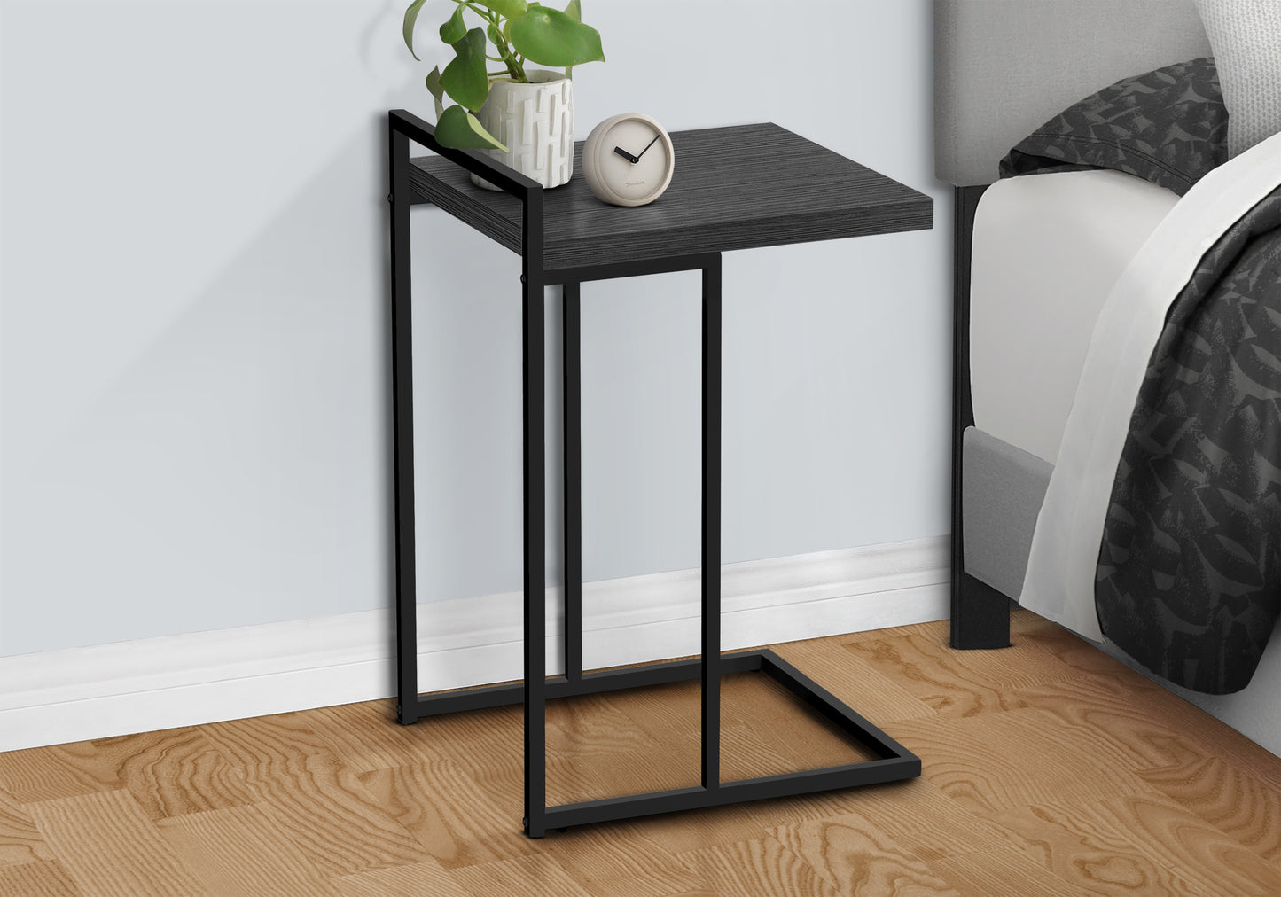 Modern Ctable with black metal frame and dark wood tabletop ideal for bedside use